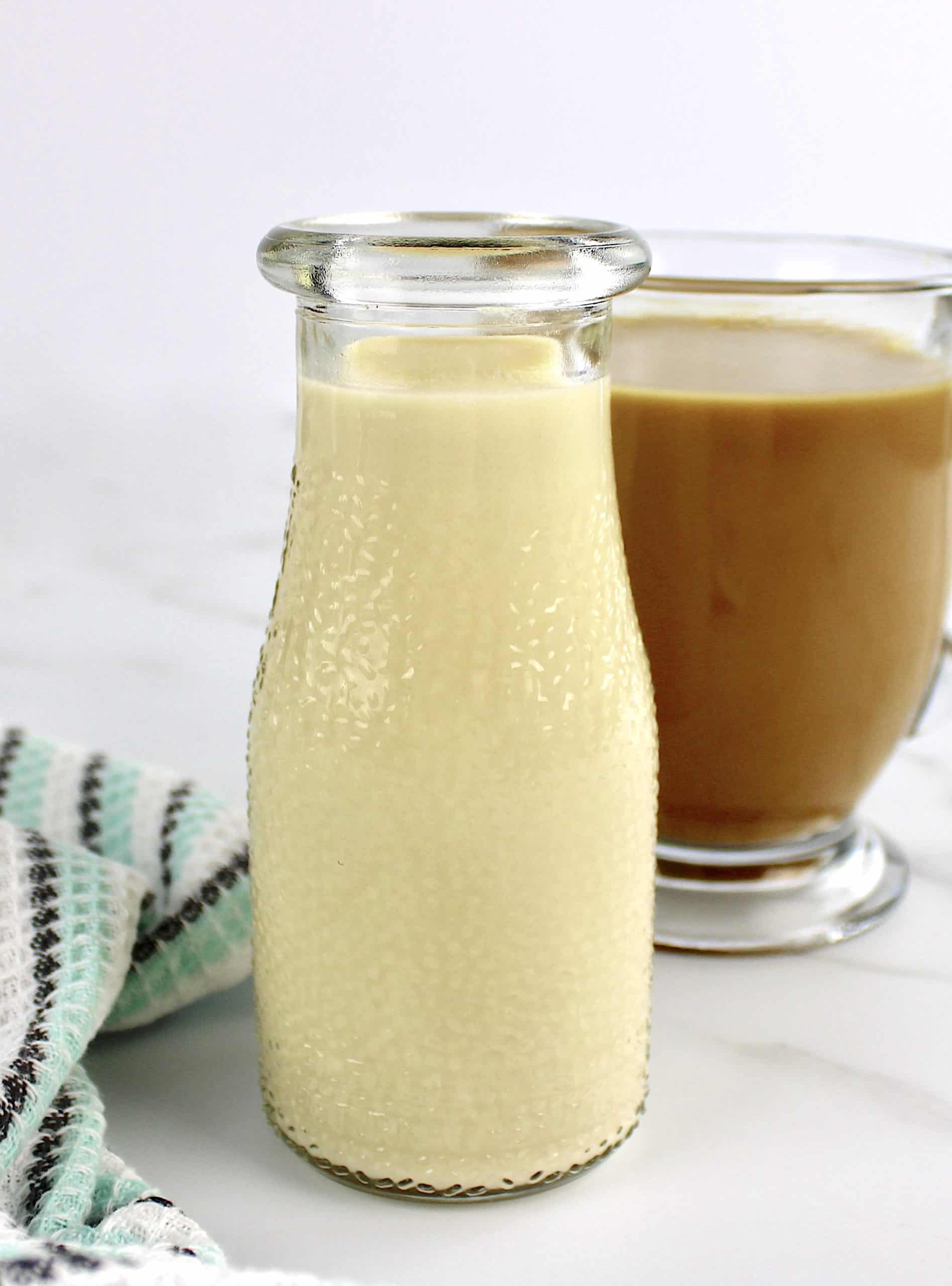 Keto Coffee Creamer in glass jar with coffee in background