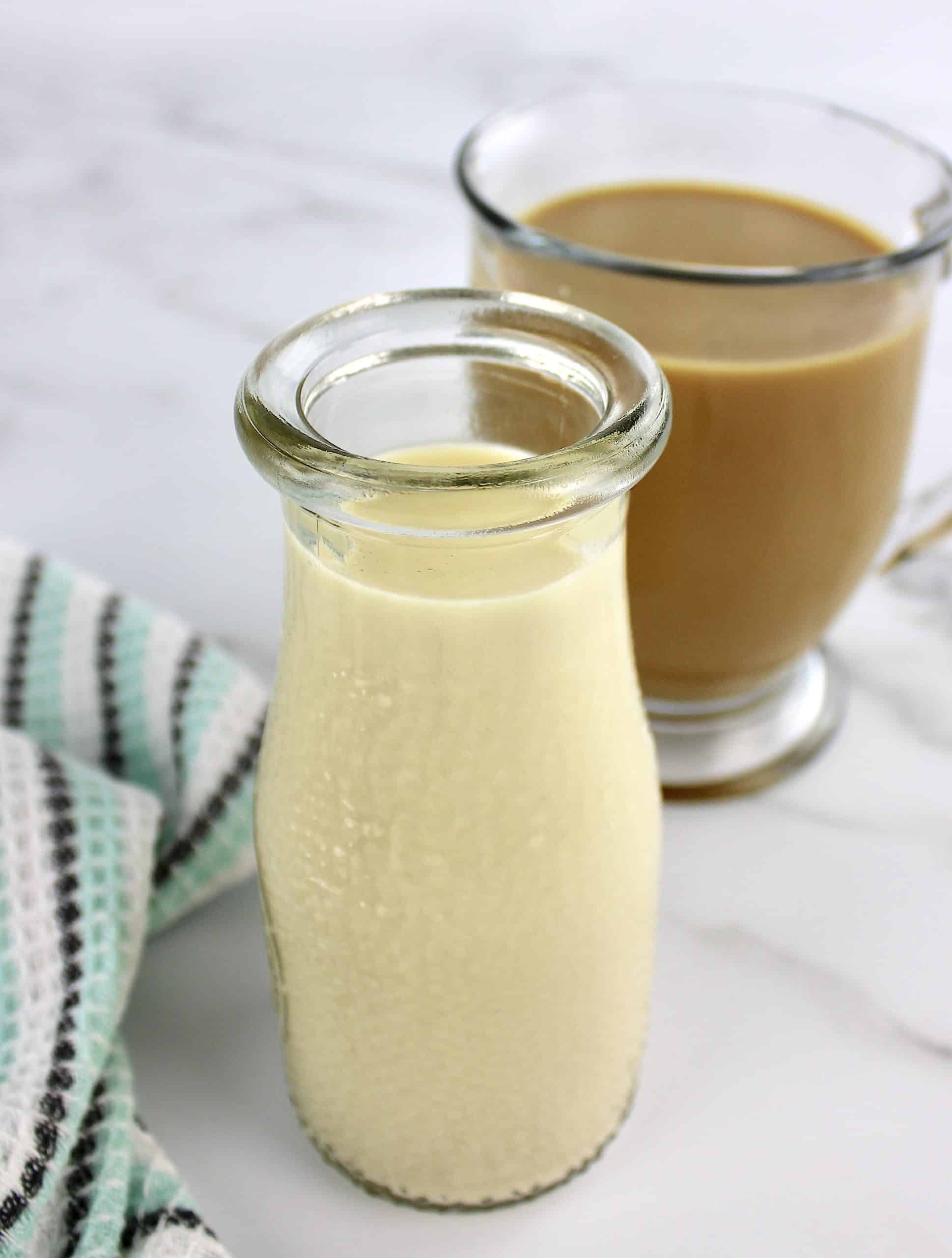 Keto Coffee Creamer in glass jar with coffee in background