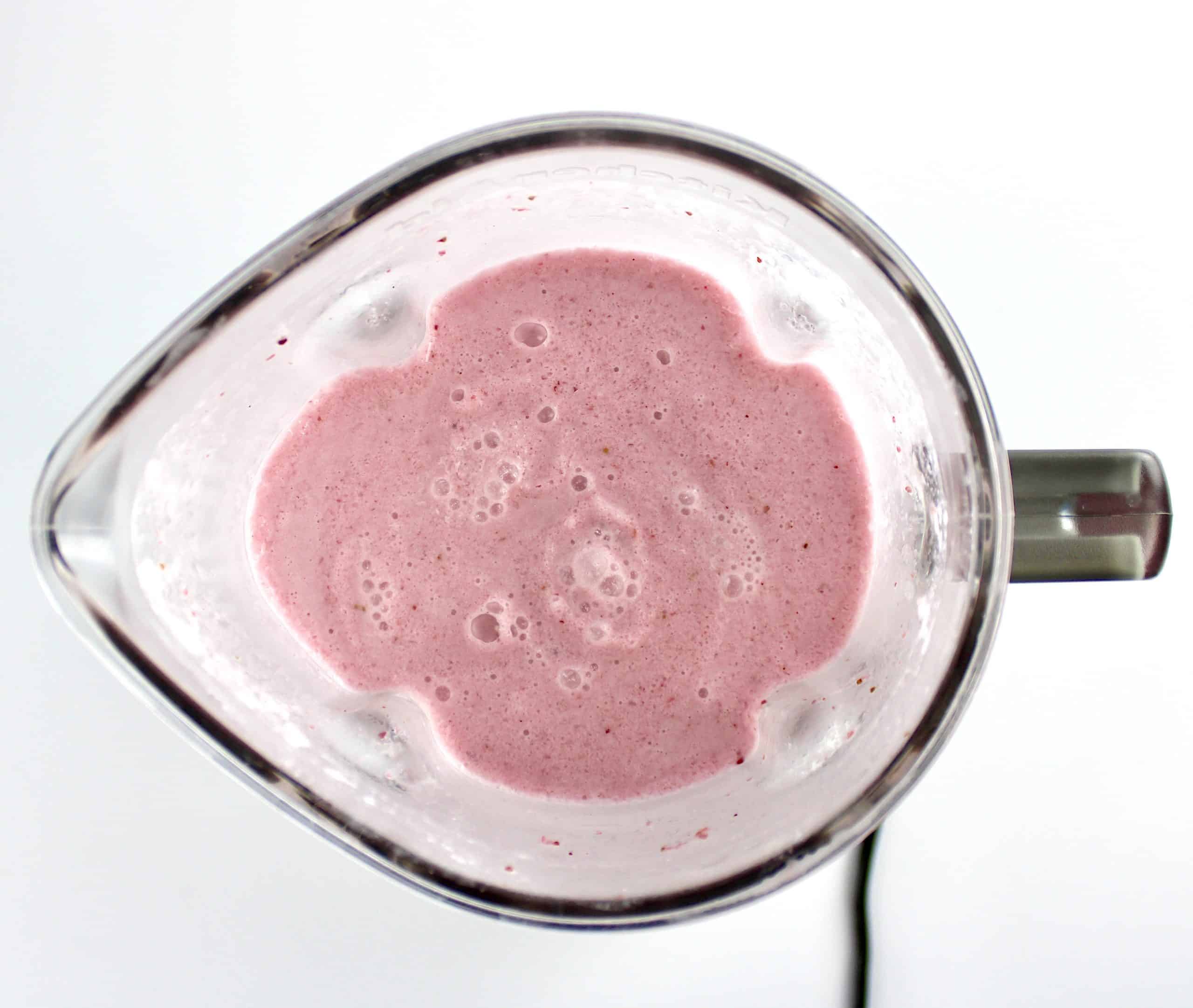 overhead view of cranberry smoothie in blender
