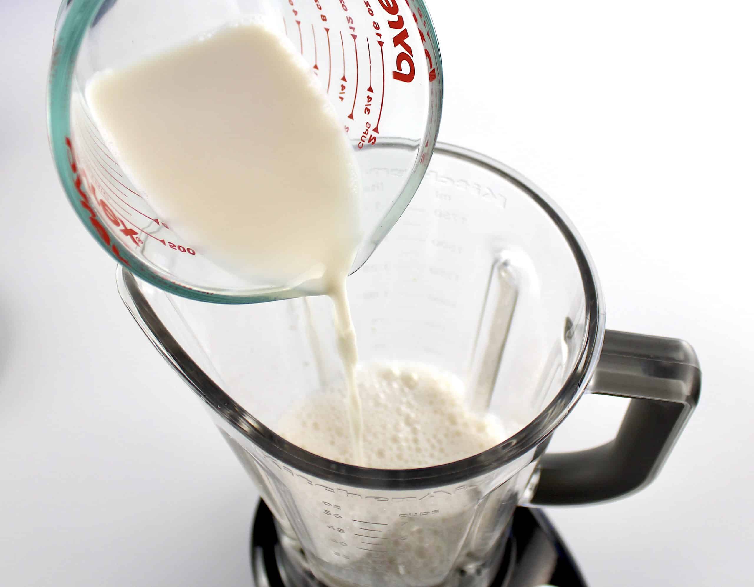 almond milk being poured into blender