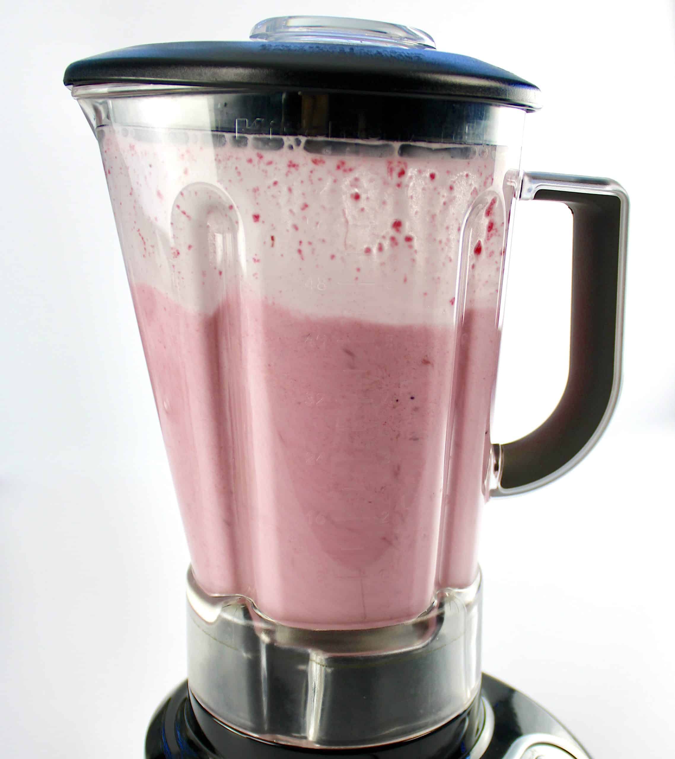 side view of cranberry smoothie in blender