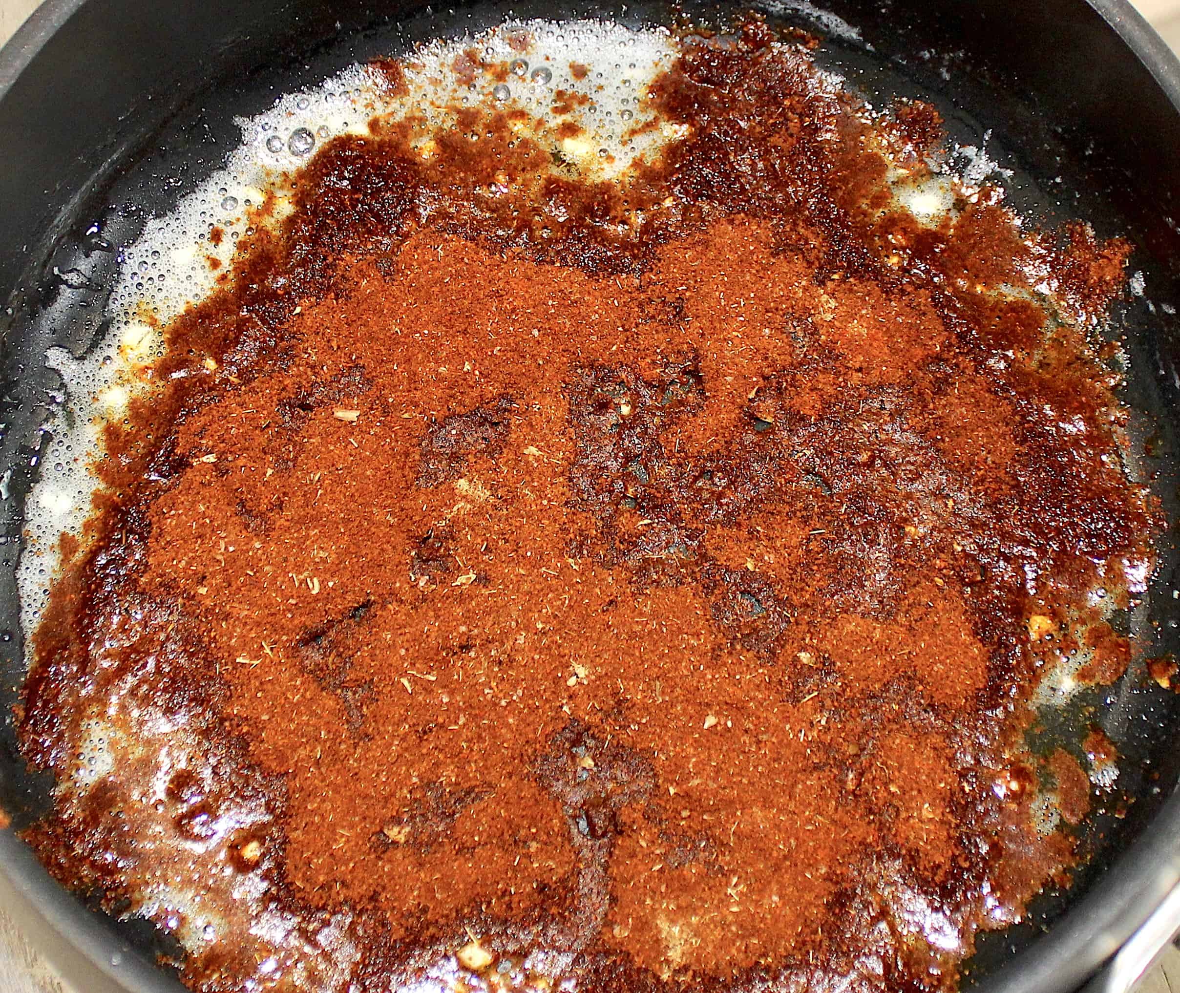 spices toasting in skillet with butter