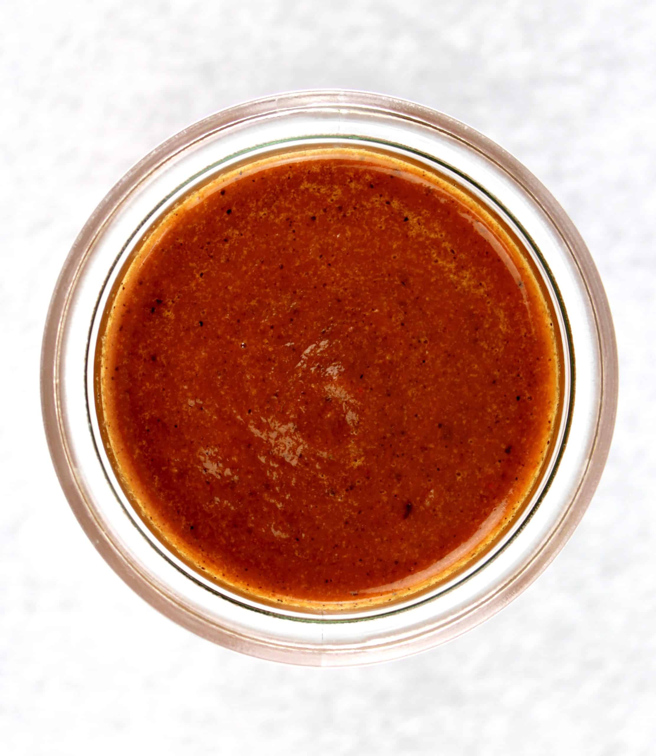 overhead view of Keto Enchilada Sauce in open glass jar