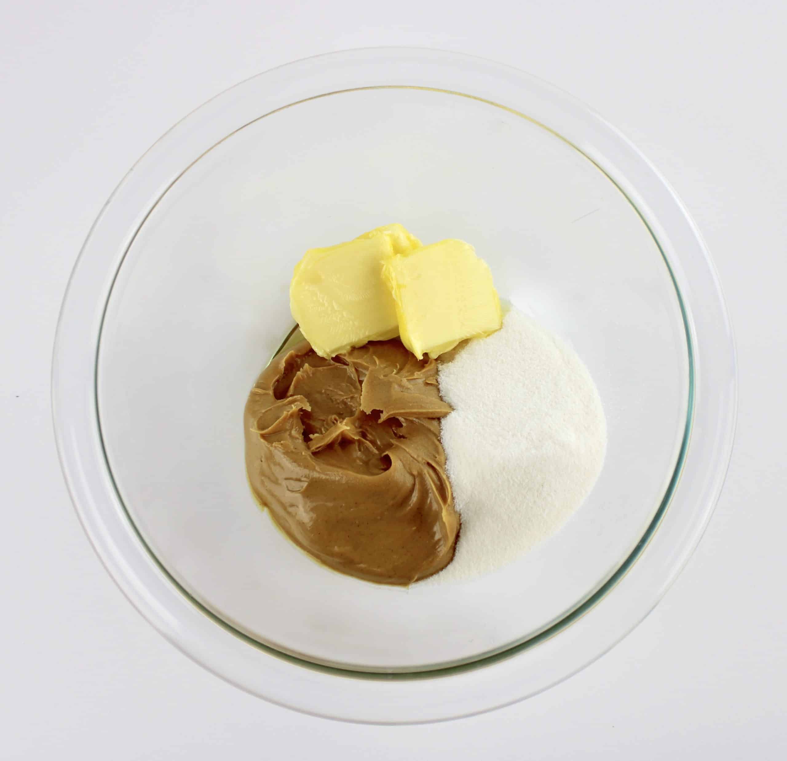 peanut butter butter and sweetener in glass mixing bowl unmixed