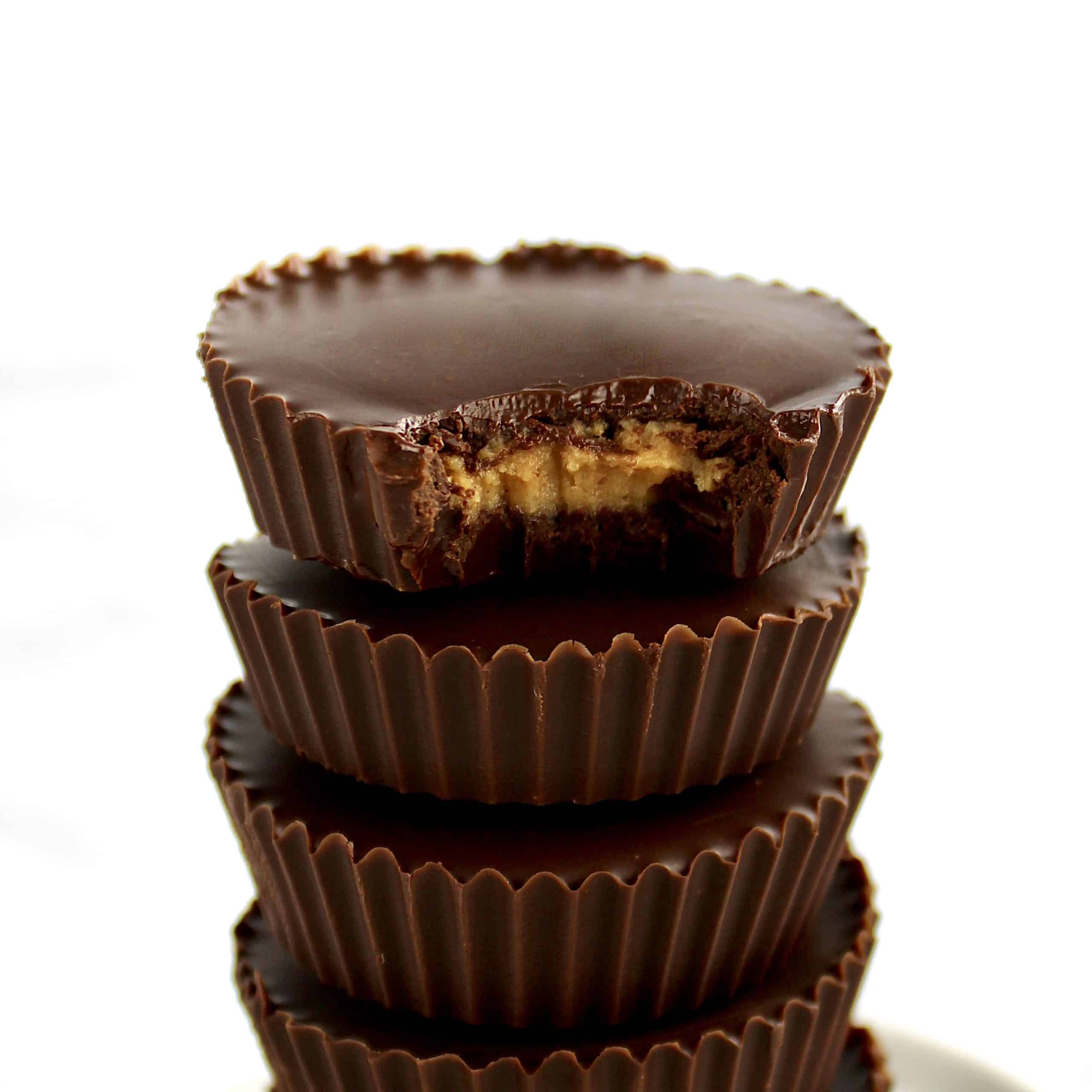 Keto Peanut Butter Cups stacked with bite missing from the top one