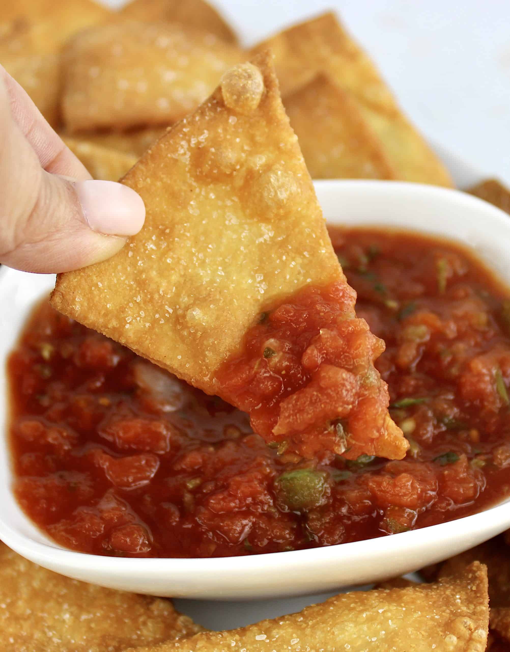 Keto Tortilla Chip being dipped into salsa