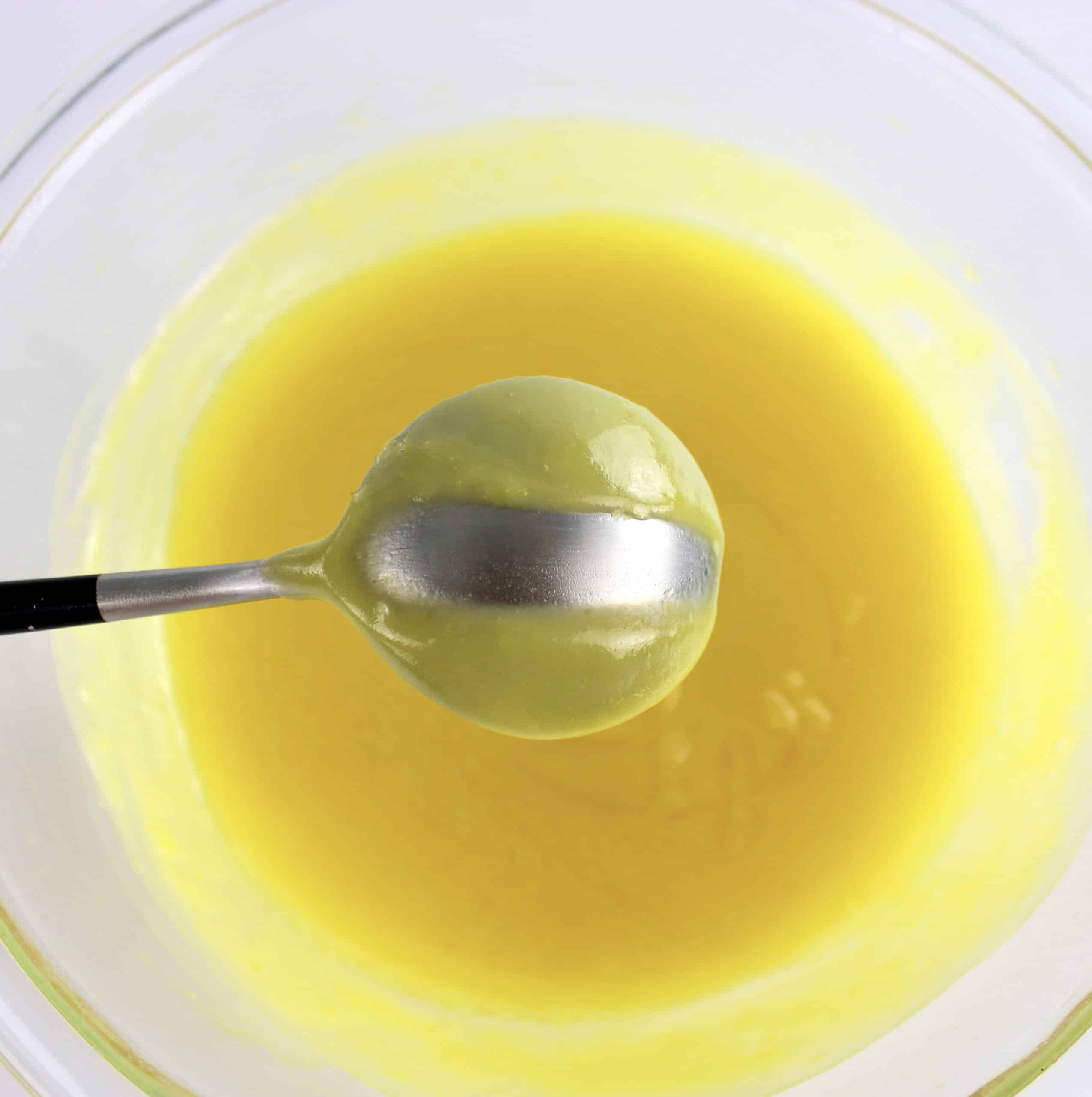 5 Minute Keto Lemon Curd on spoon with line through it