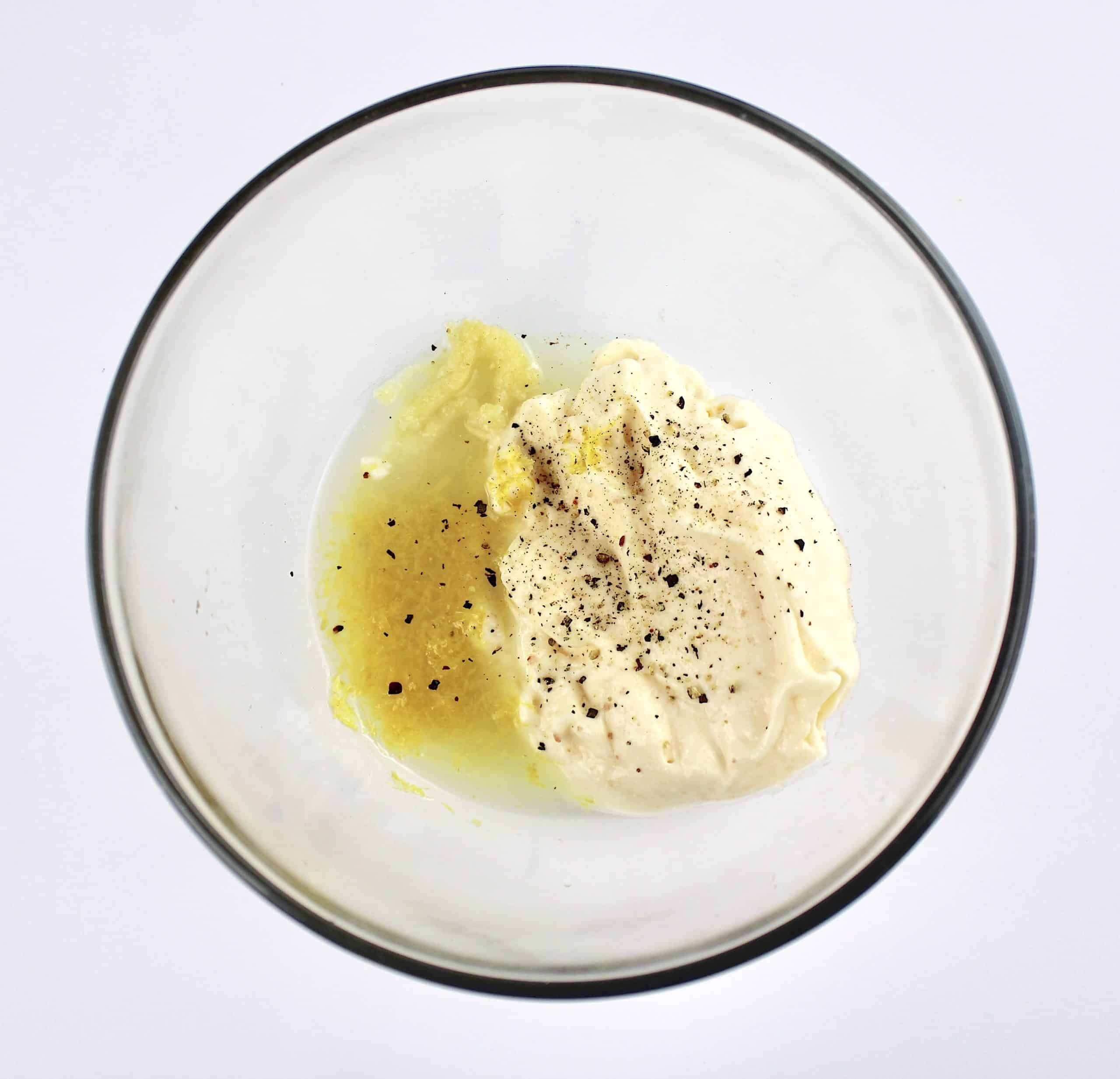garlic aioli ingredients in glass bowl unmixed