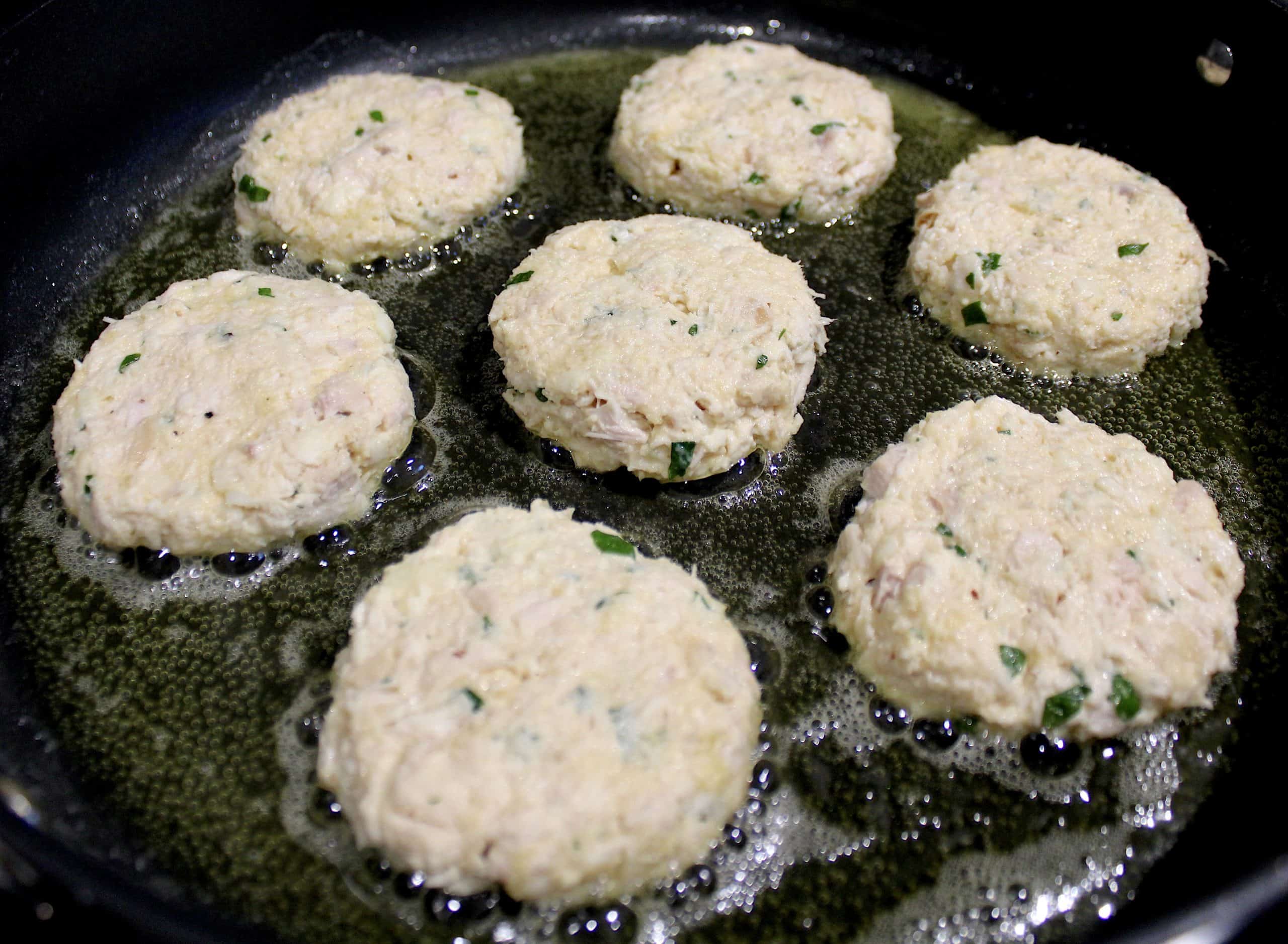 chicken patties frying in skillet