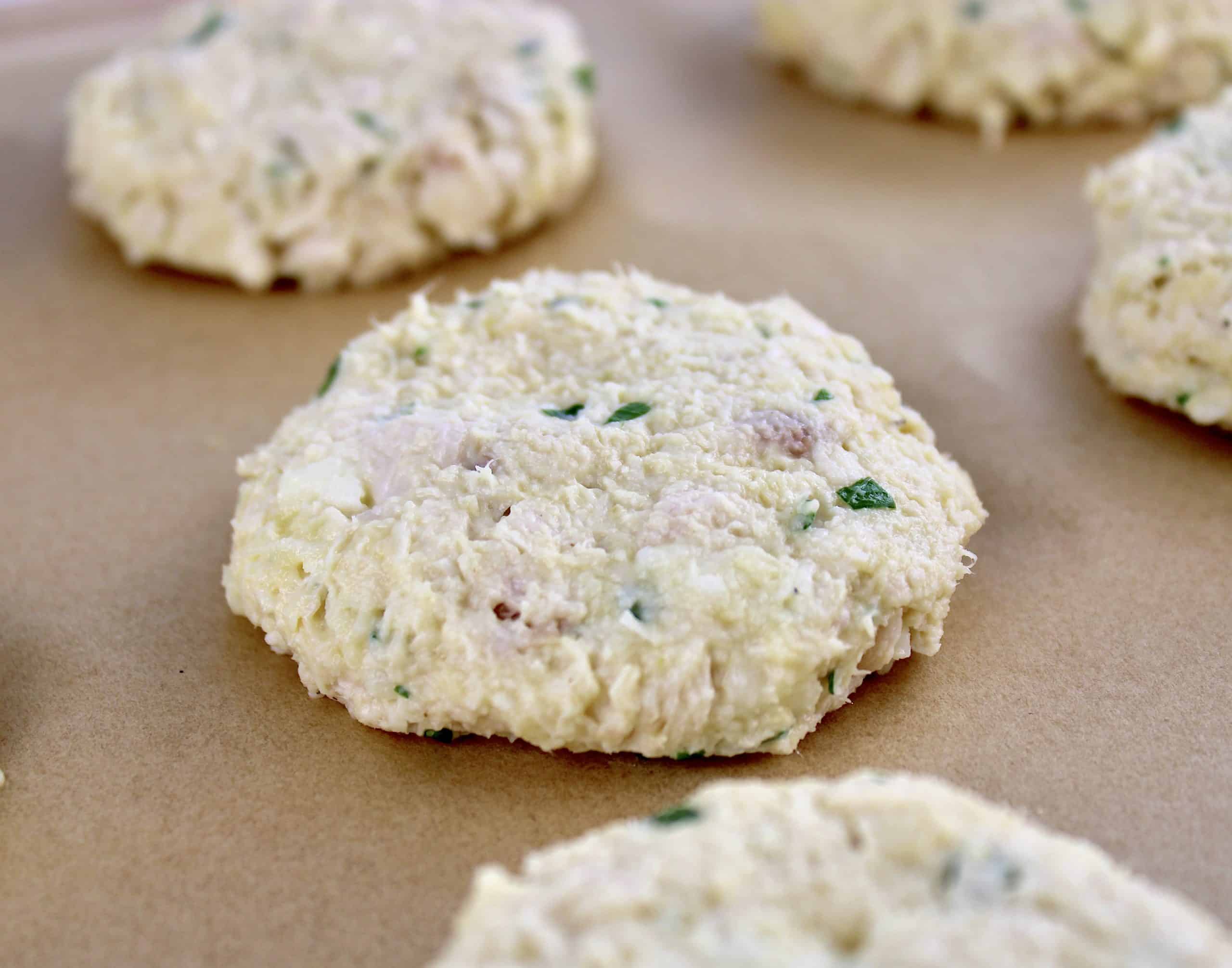 chicken patties uncooked on parchment paper