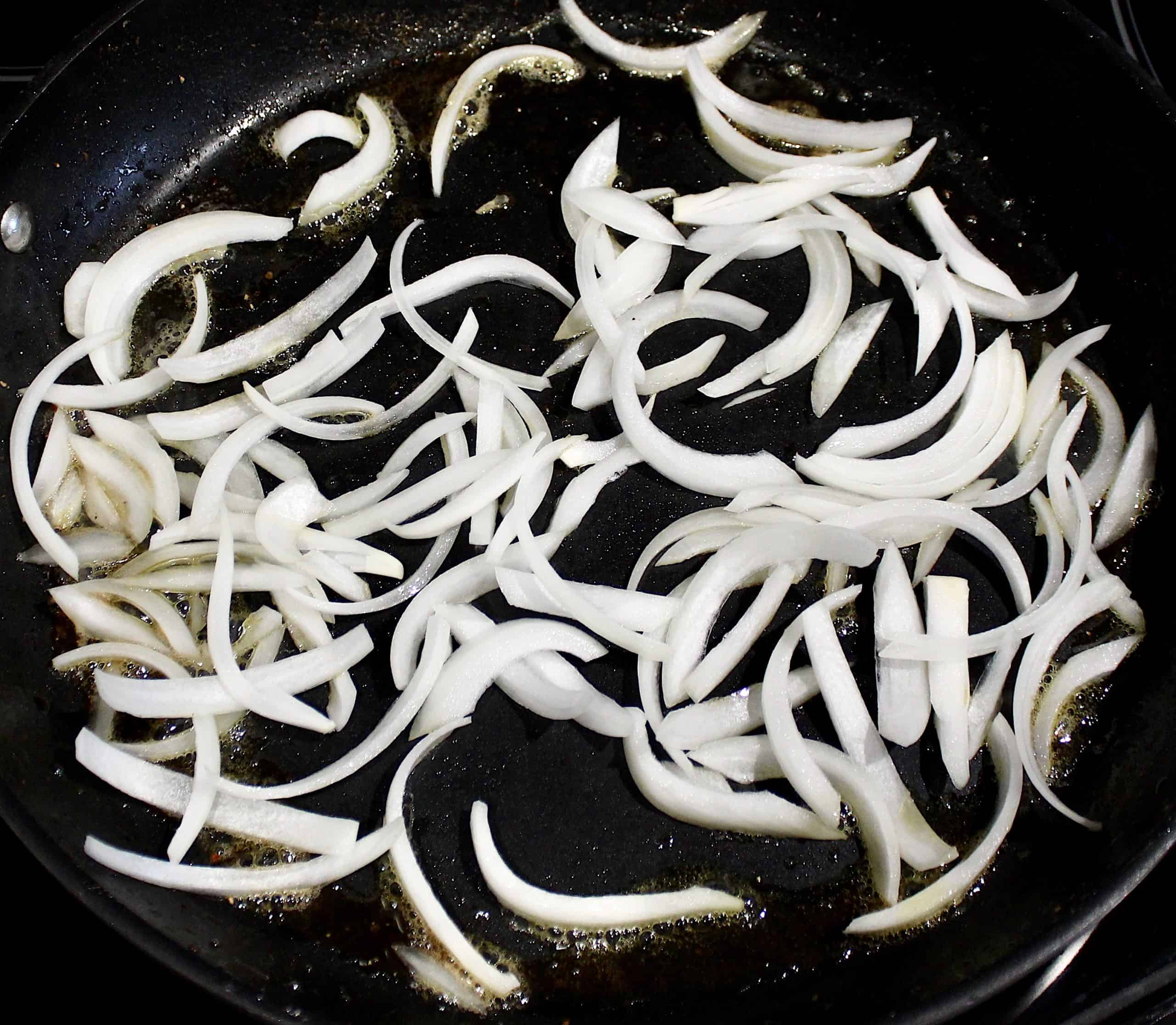 onion slices sauteing in skillet