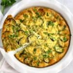 Crustless Zucchini Quiche with slice being held up
