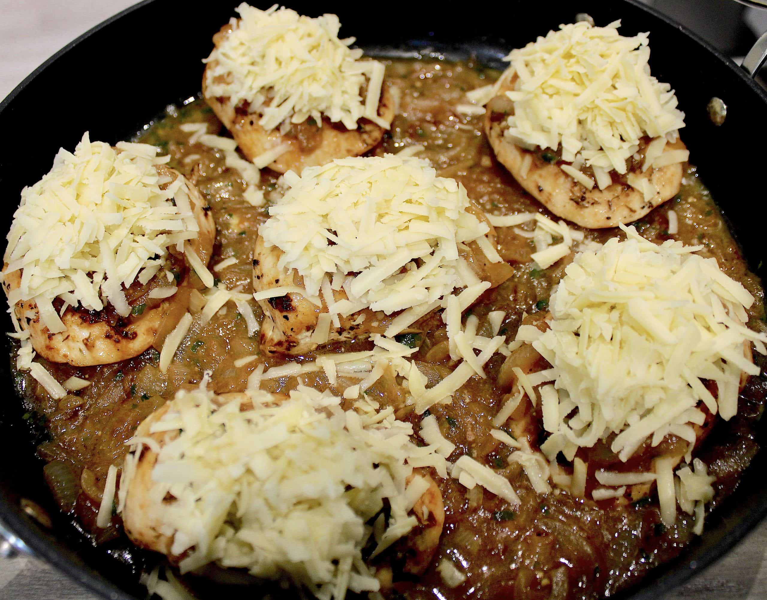 french onion chicken with shredded white cheese on top