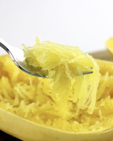 spaghetti squash strands being held up with fork