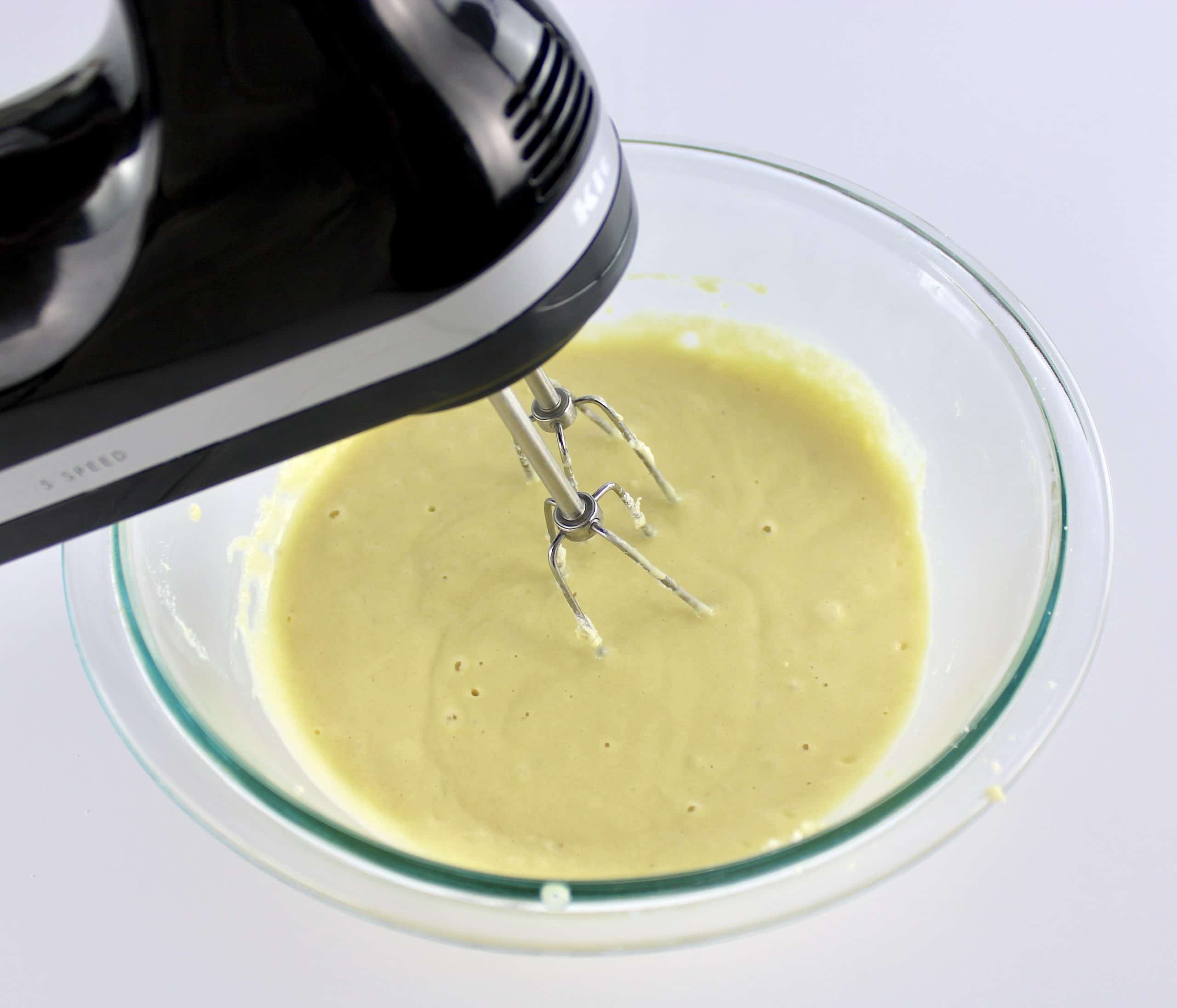 keto buttermilk pancake batter being mixed with hand mixer in glass bowl
