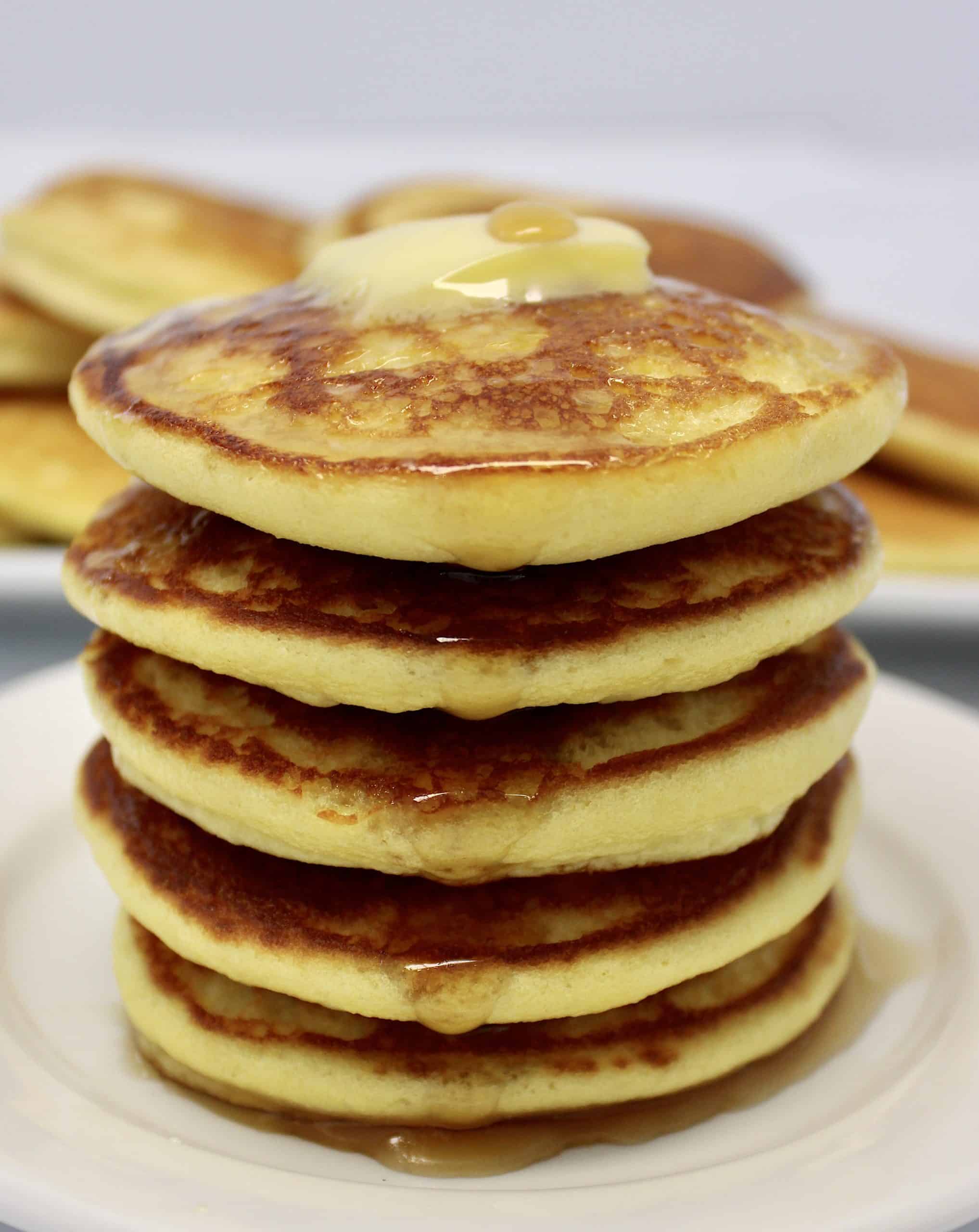 stack of pancakes with butter on top