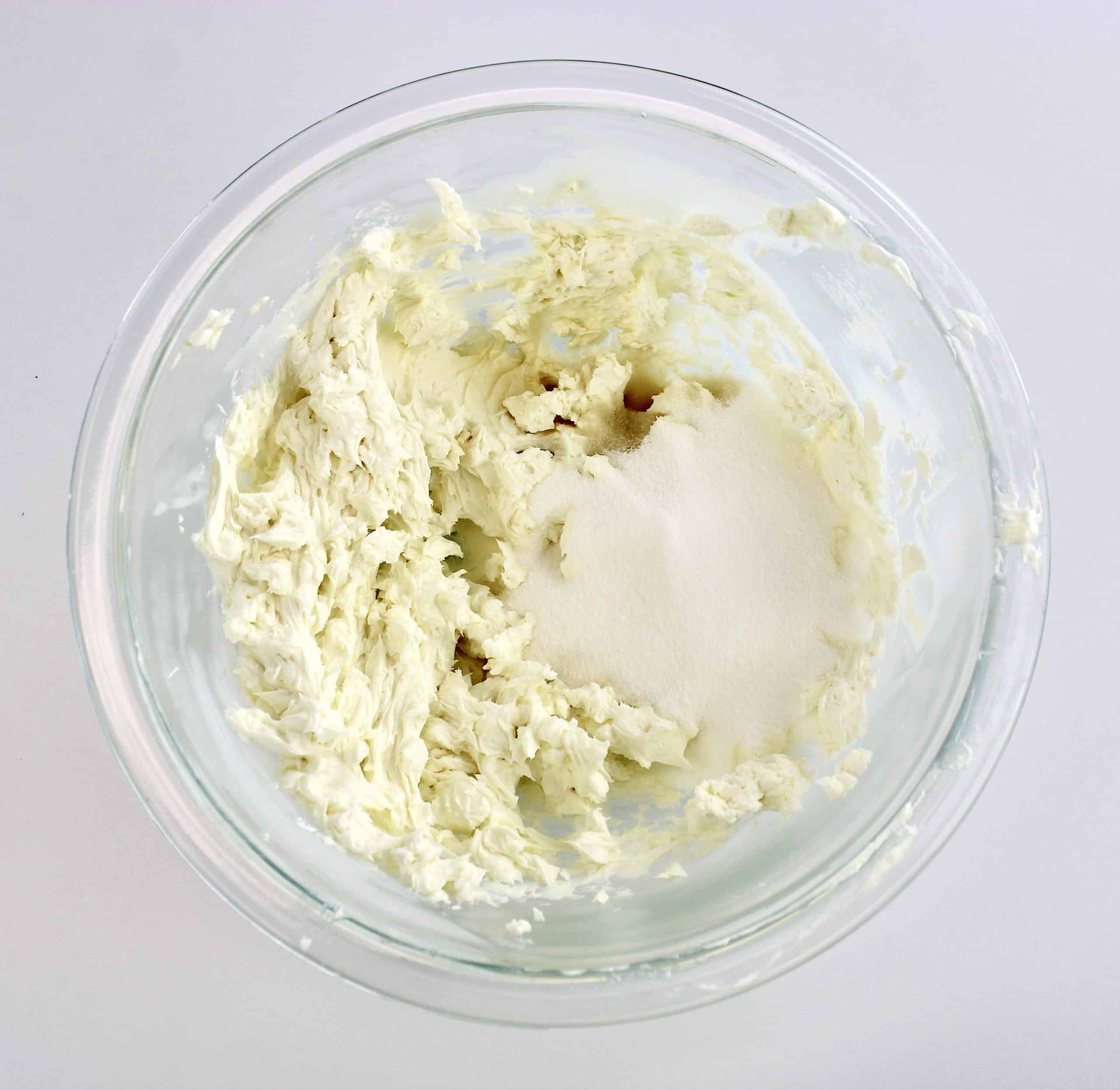 whipped cream cheese sweetener and vanilla in glass bowl unmixed
