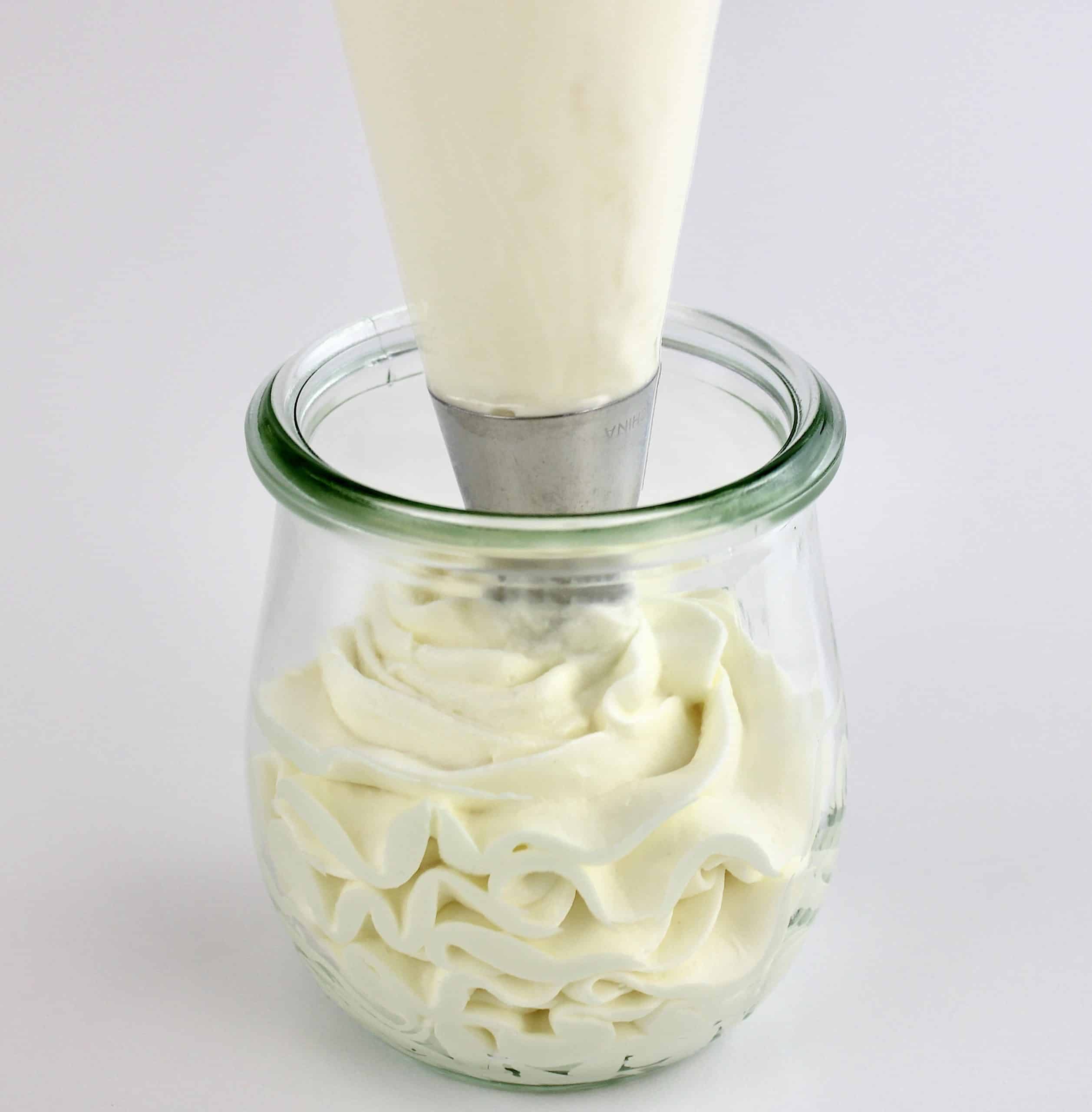 Keto Cheesecake Fluff being piped into glass jar