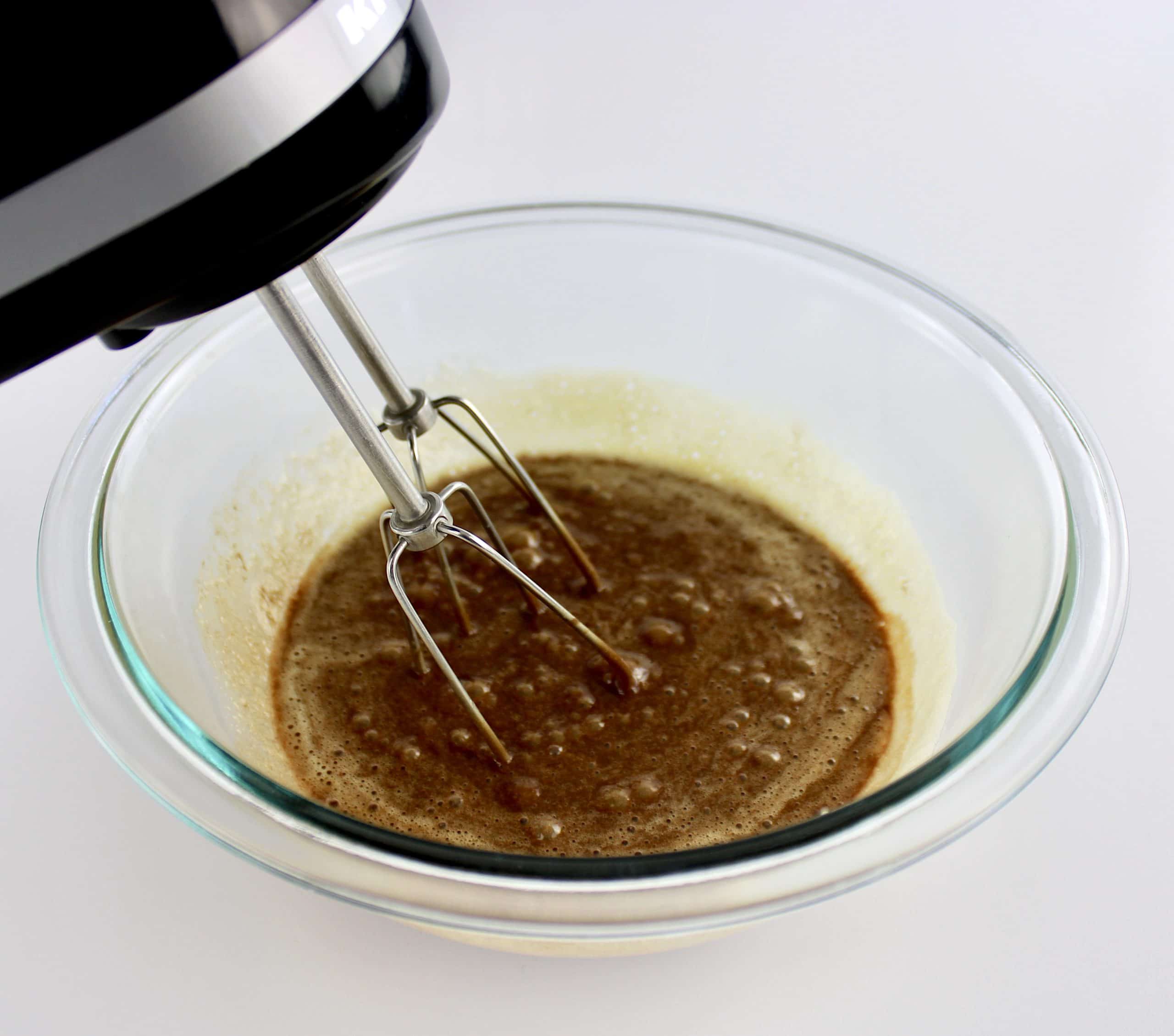 chocolate lava cake batter being mixed with hand mixer