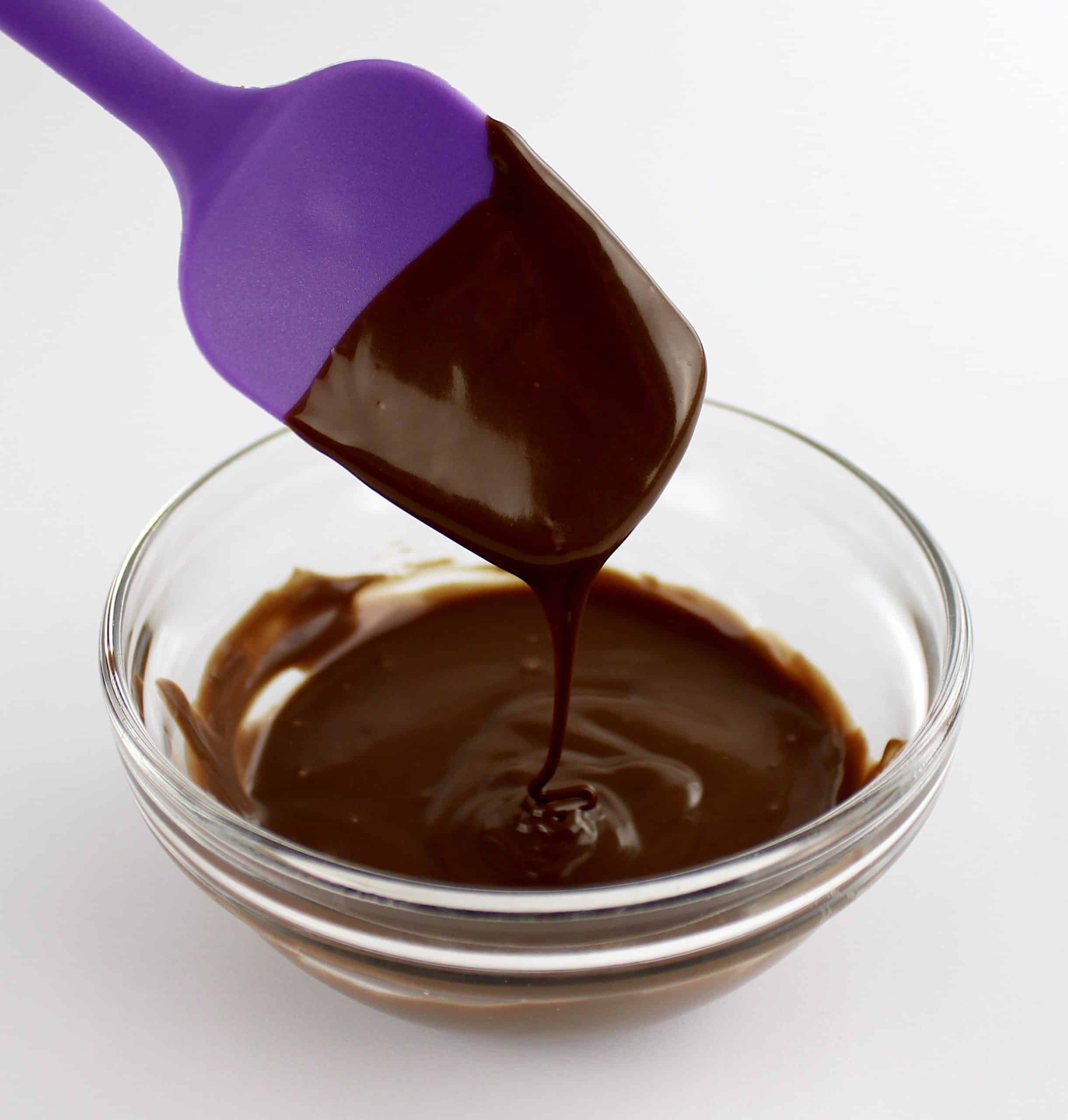 nutella melted in glass bowl with purple spatual