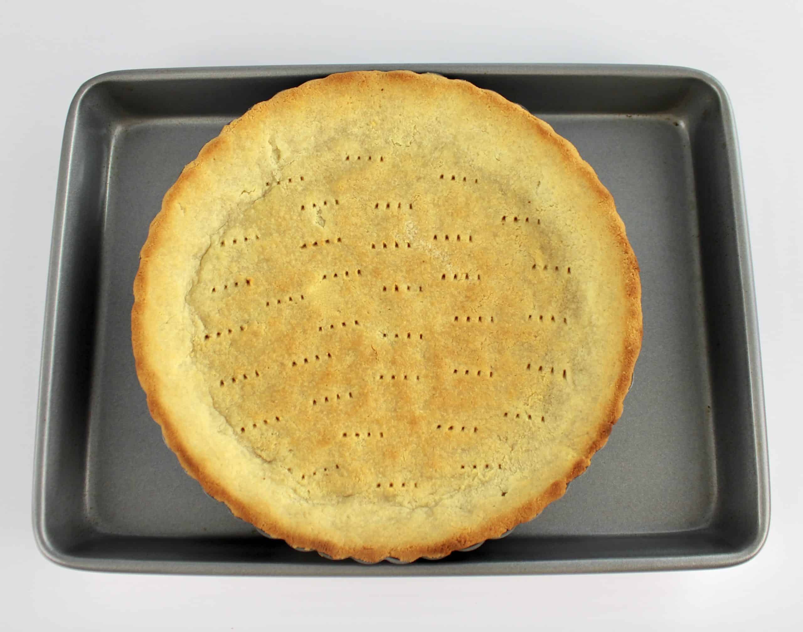 baked keto pie crust on baking sheet