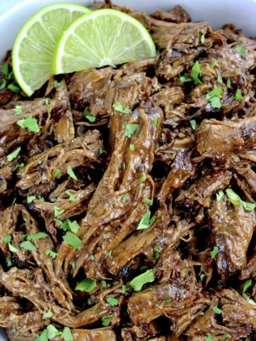 Slow Cooker Beef Barbacoa with cilantro and 2 lime slices