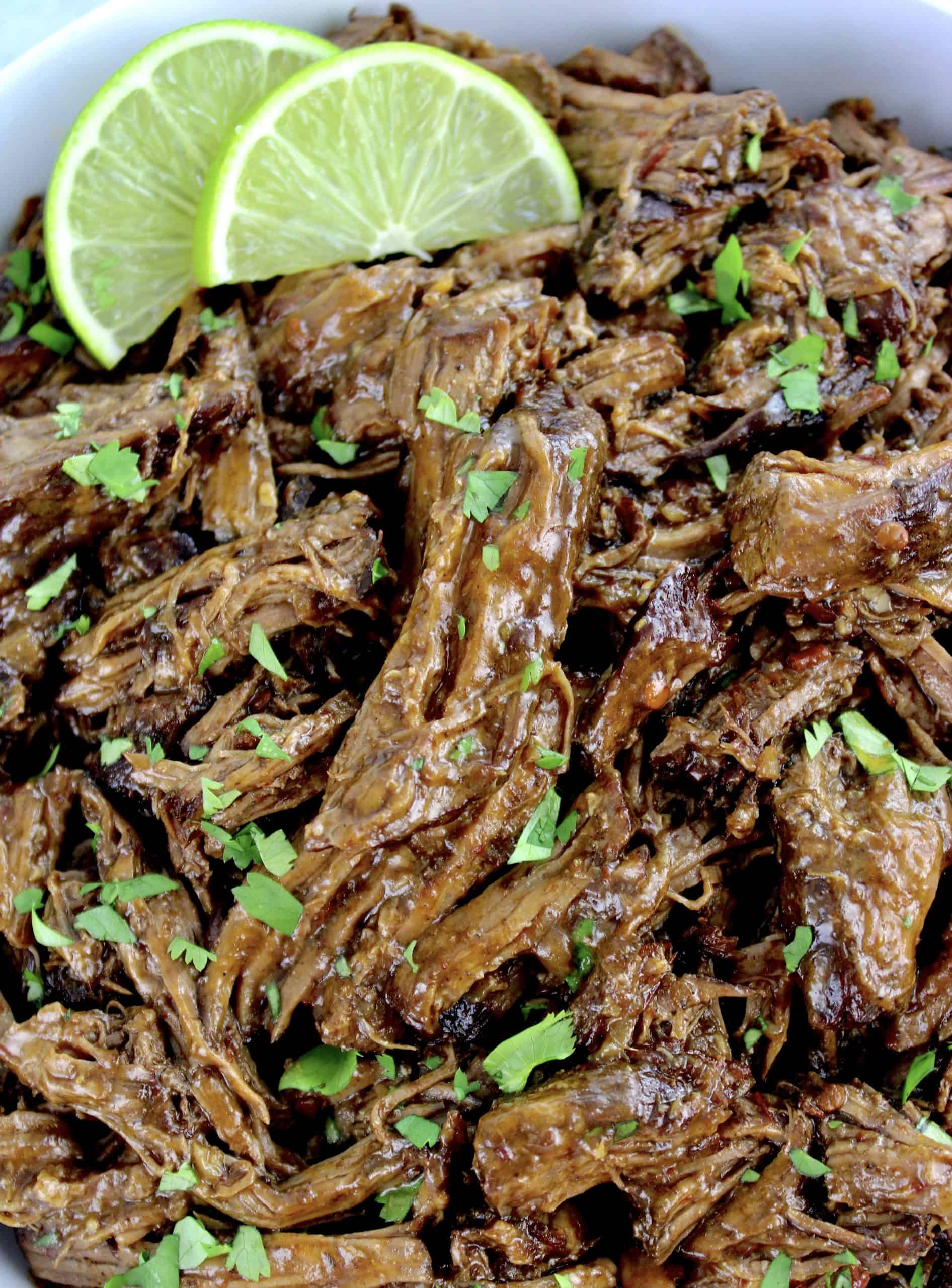 Slow Cooker Beef Barbacoa with cilantro and 2 lime slices