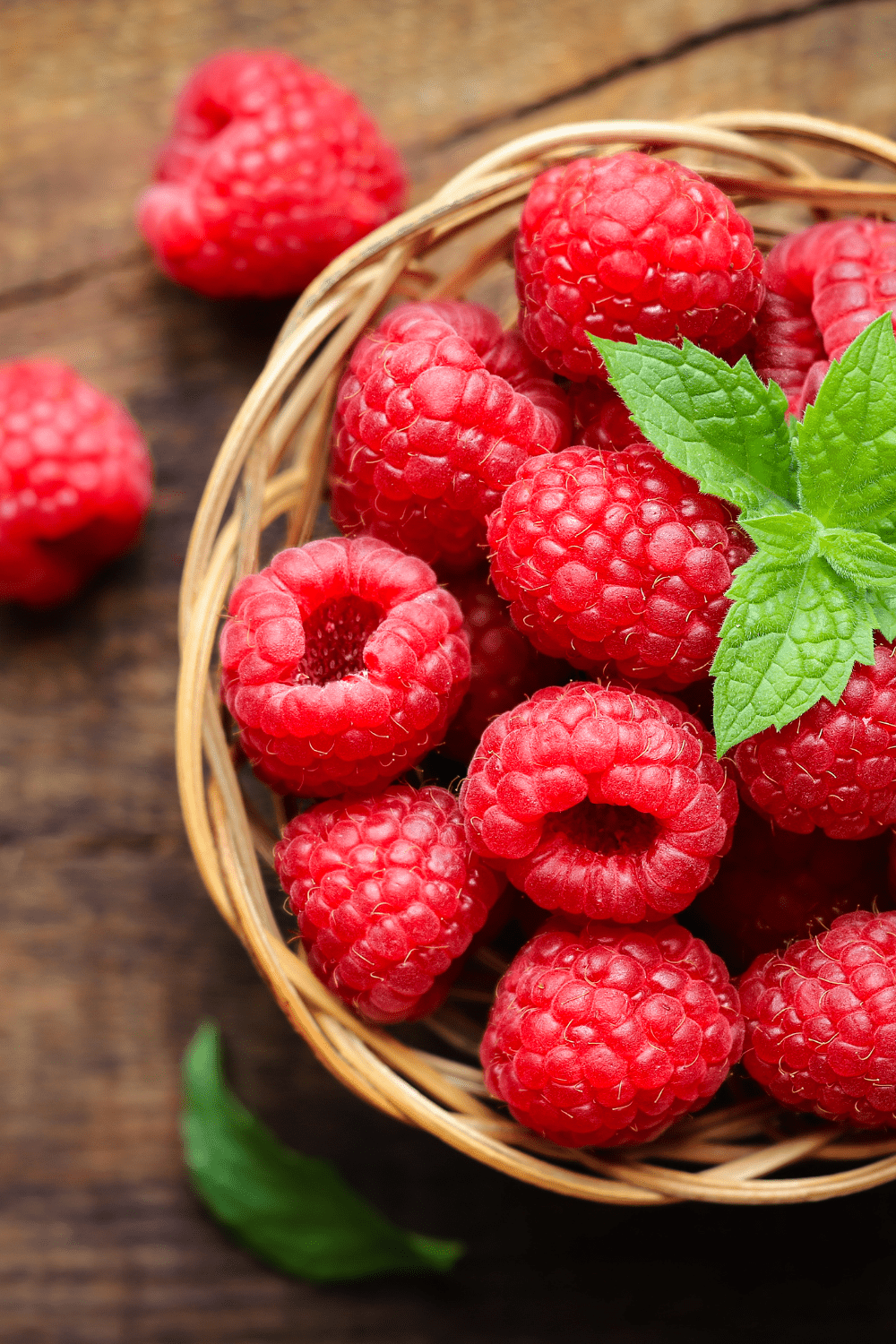 raspberries in basket with mint leaf