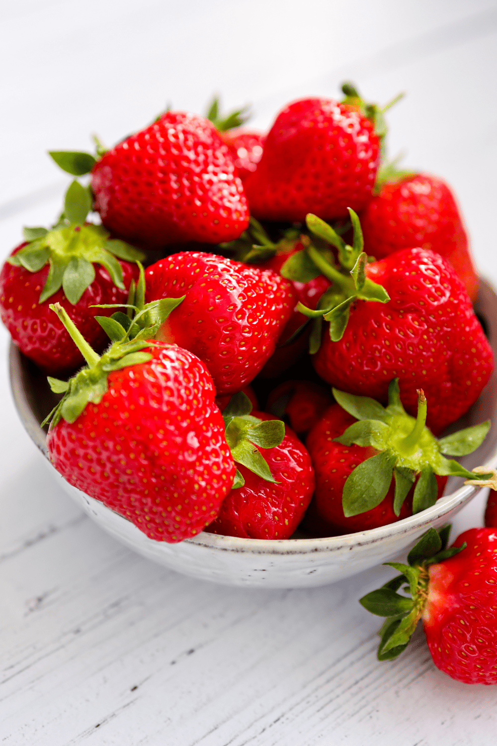 white bowl with strawberries