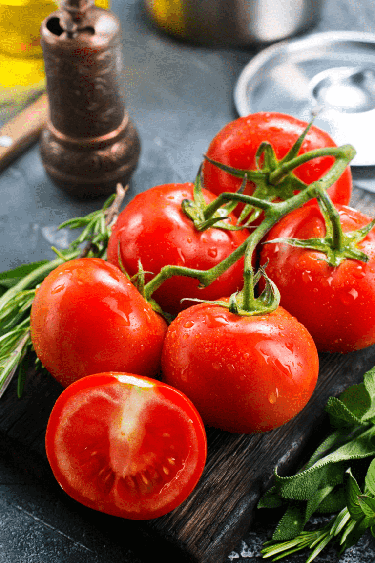tomatoes on the vine on cutting board