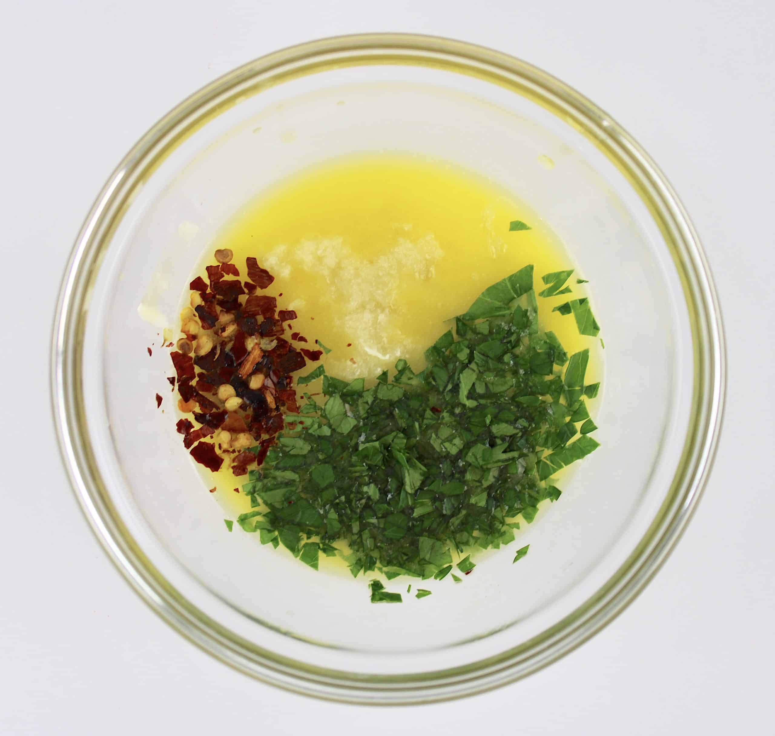 melted butter garlic parsley and red pepper flakes in glass bowl
