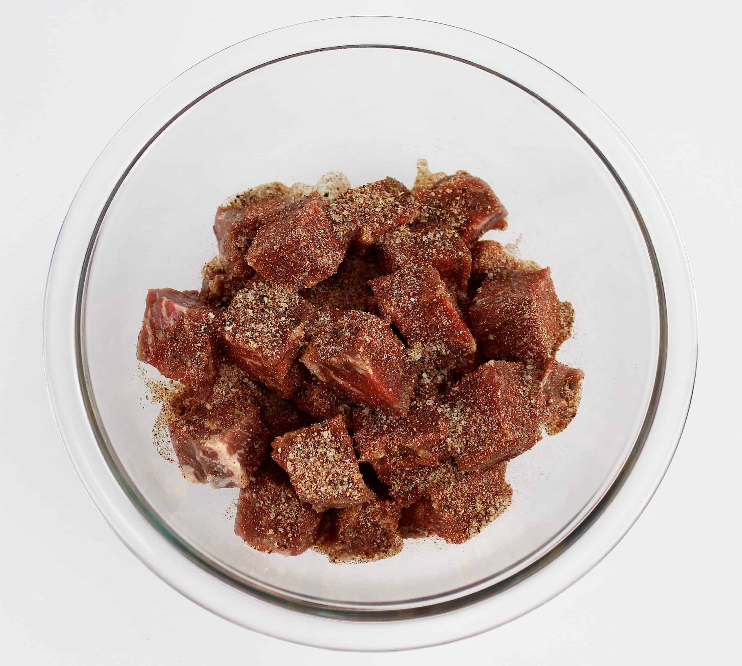 steak bites in glass bowl with spice mix on top