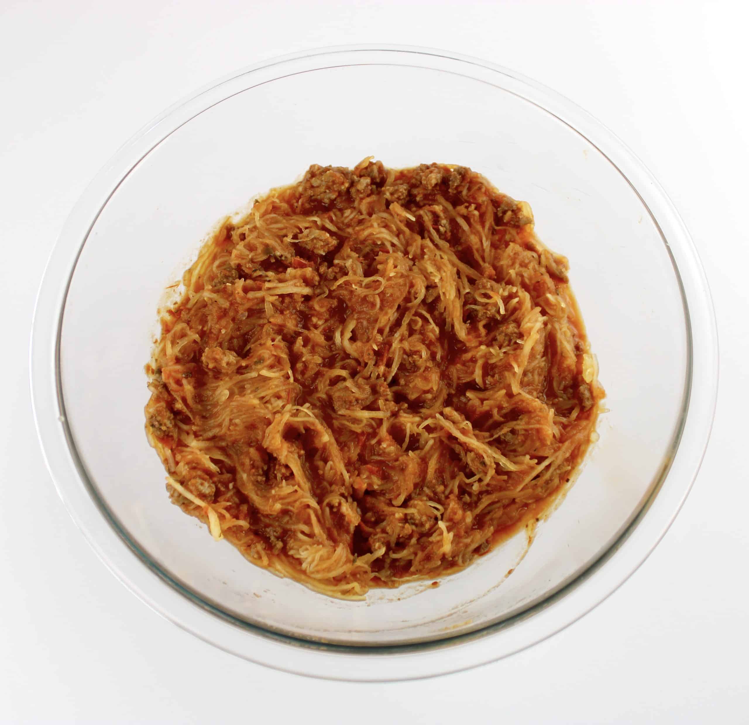 spaghetti squash mixed with italian meat sauce in glass bowl