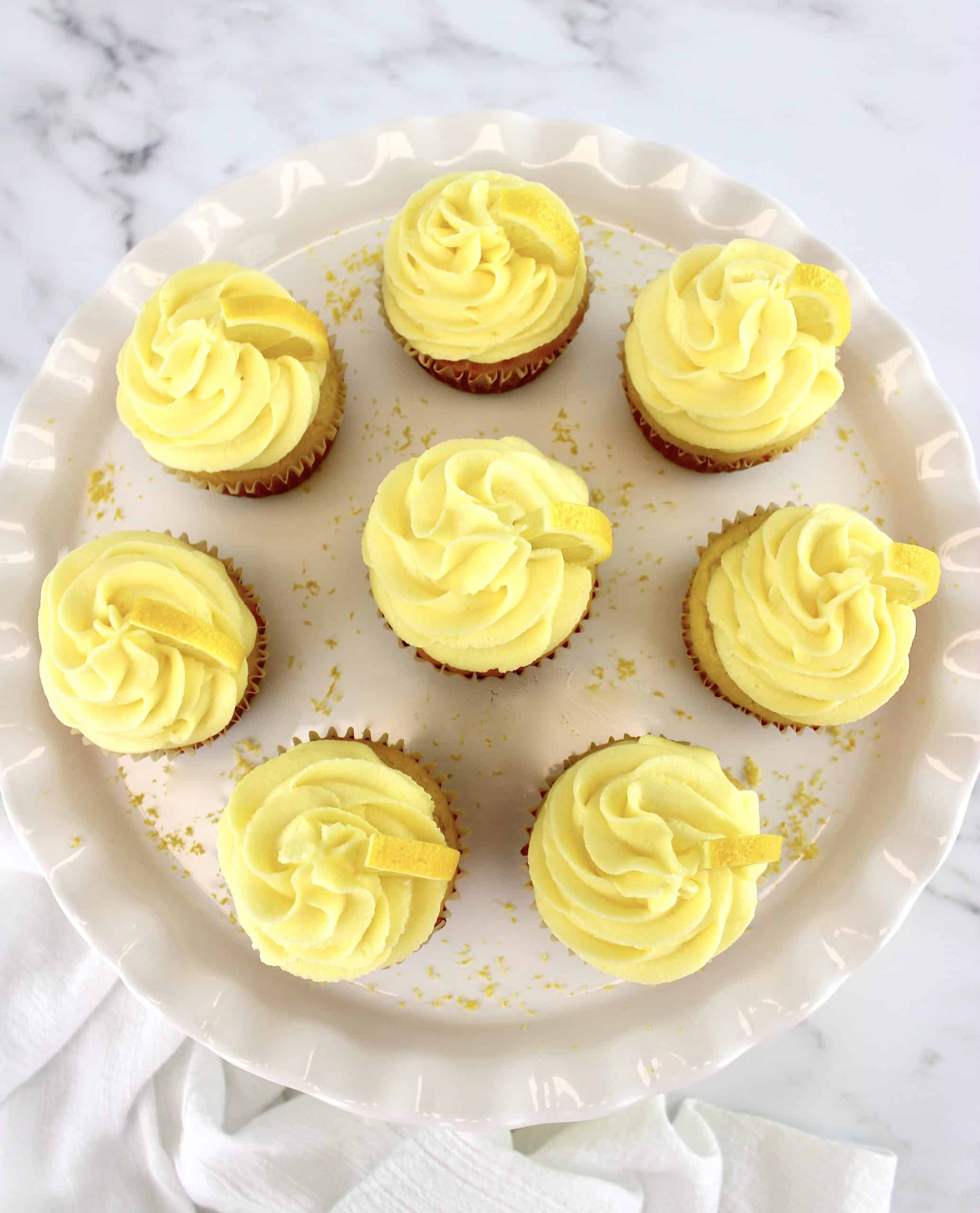 overhead view of lemon cupcakes on white cake stand