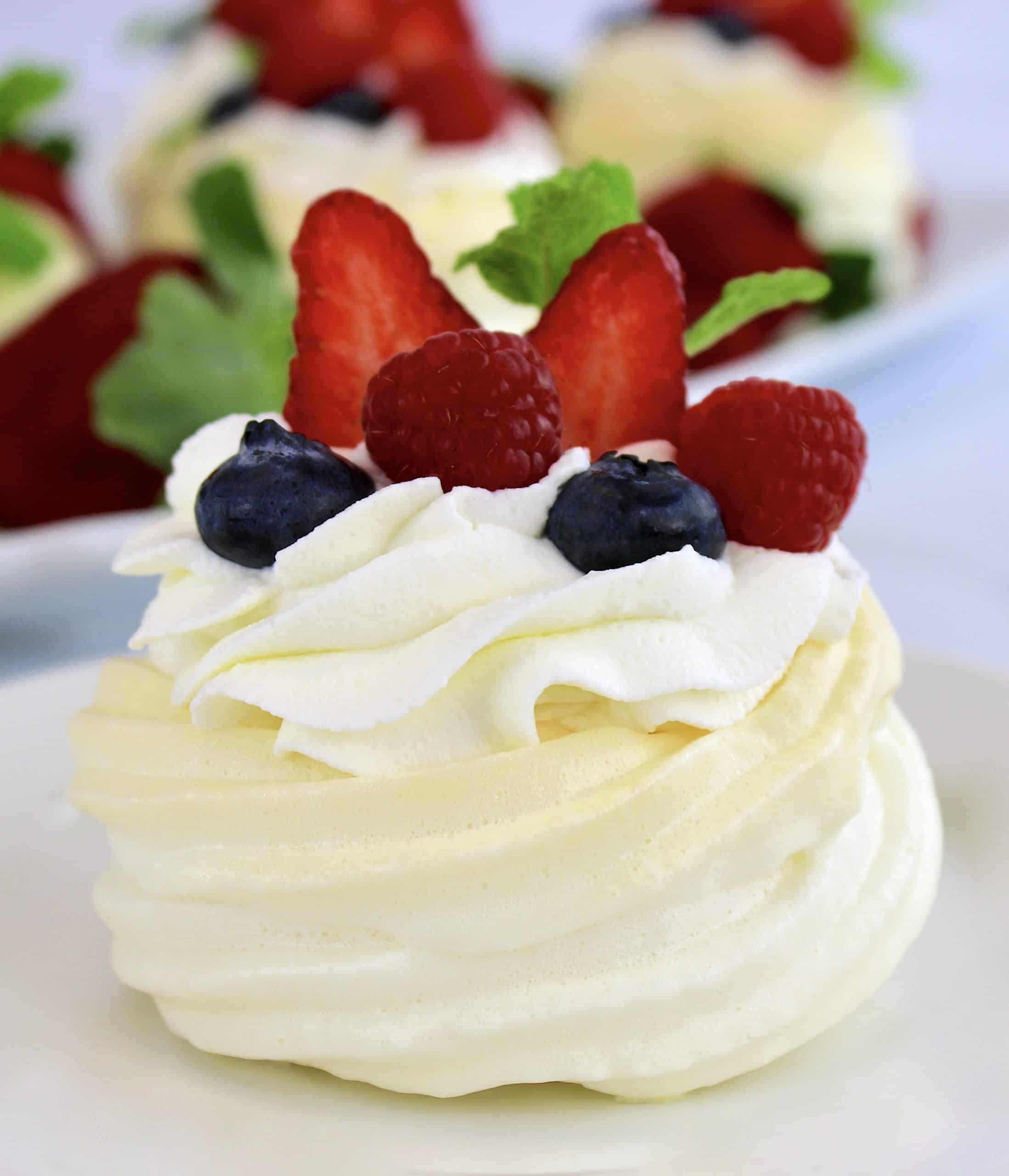 closeup of Mini Keto Pavlova with whip cream and berries on top