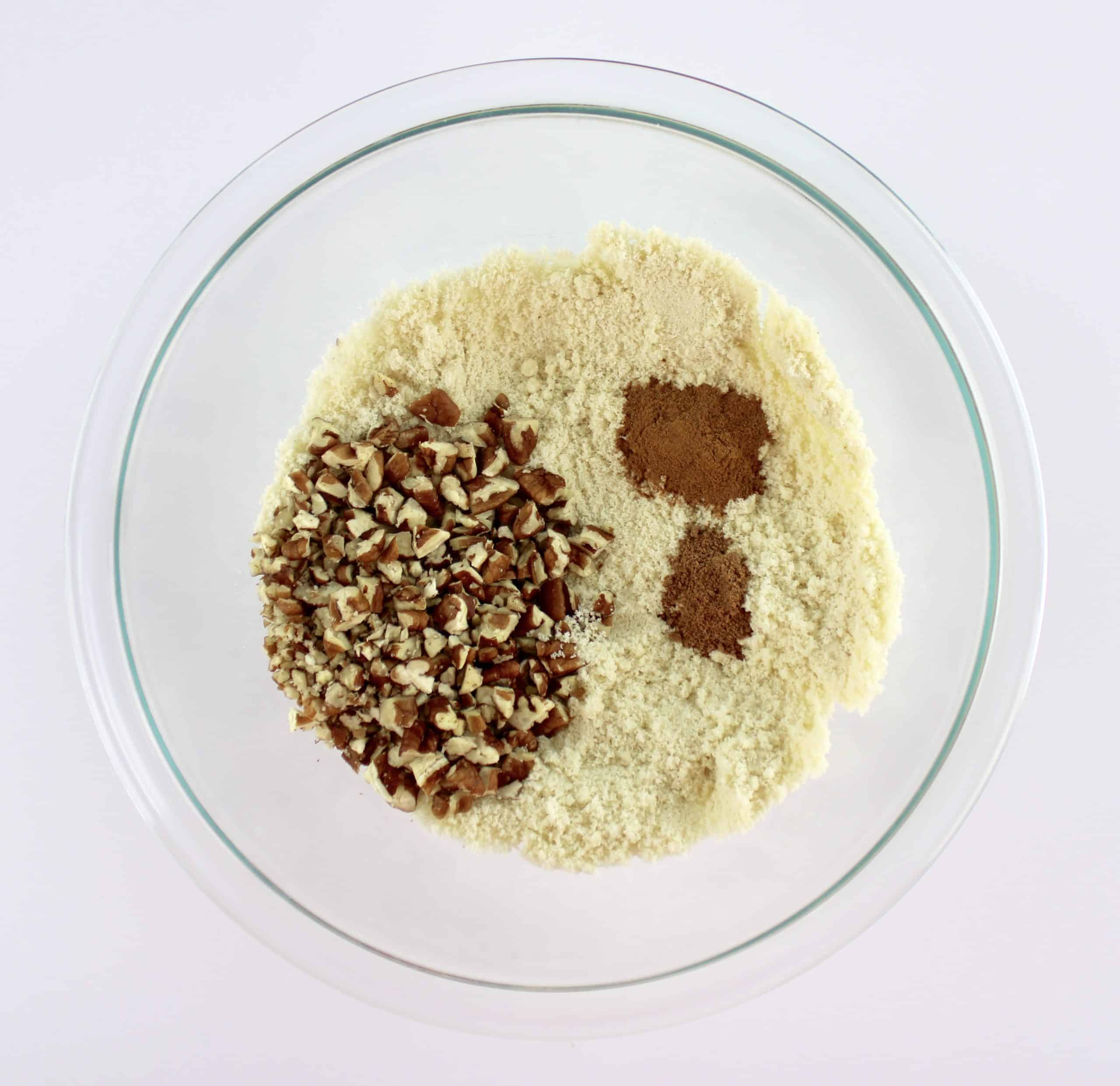 almond flour spices and chopped pecans in glass bowl unmixed