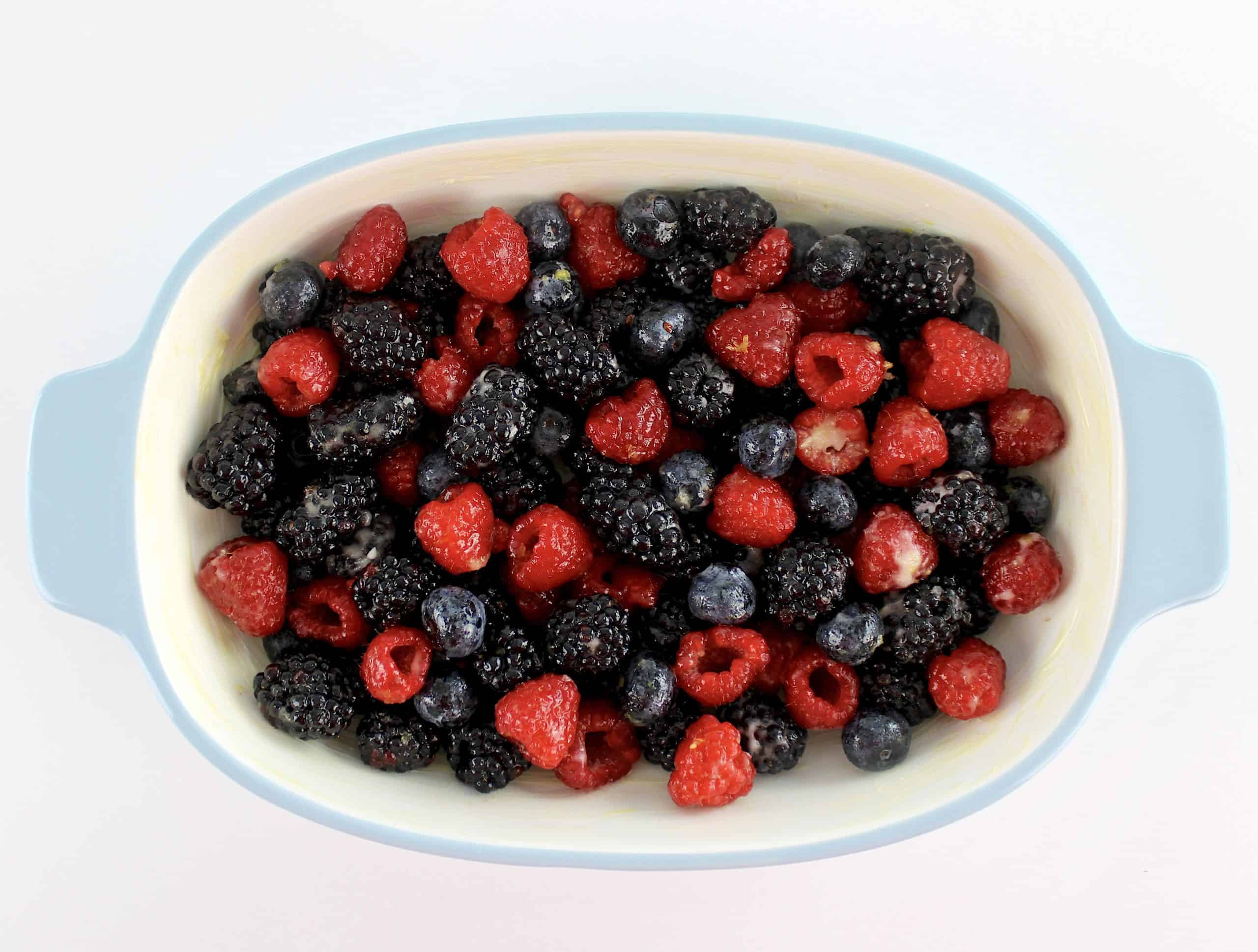 mix of berries tossed in sweetener in casserole baking dish