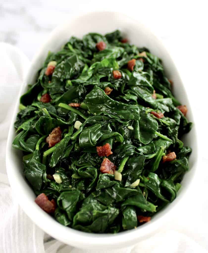 Sautéed Spinach with Pancetta in white bowl