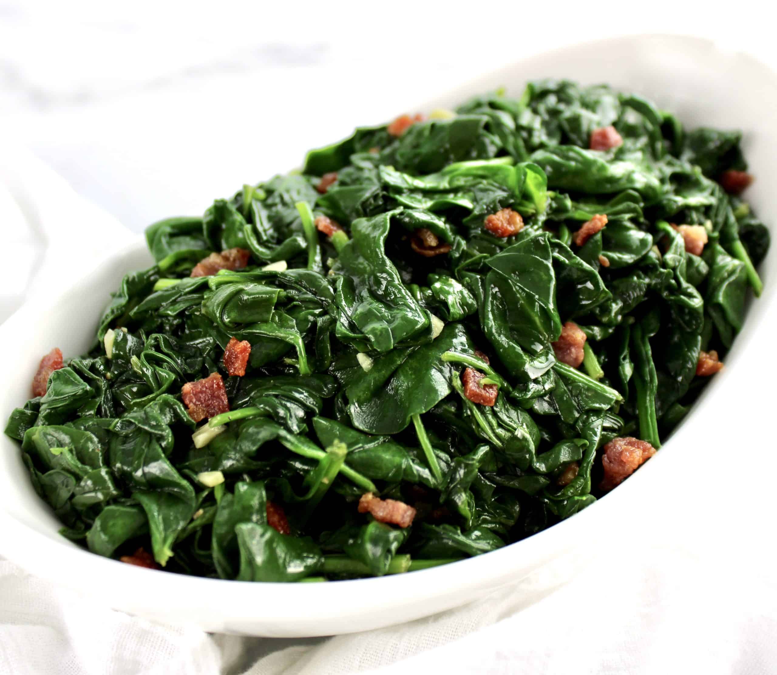 Sautéed Spinach with Pancetta in white bowl
