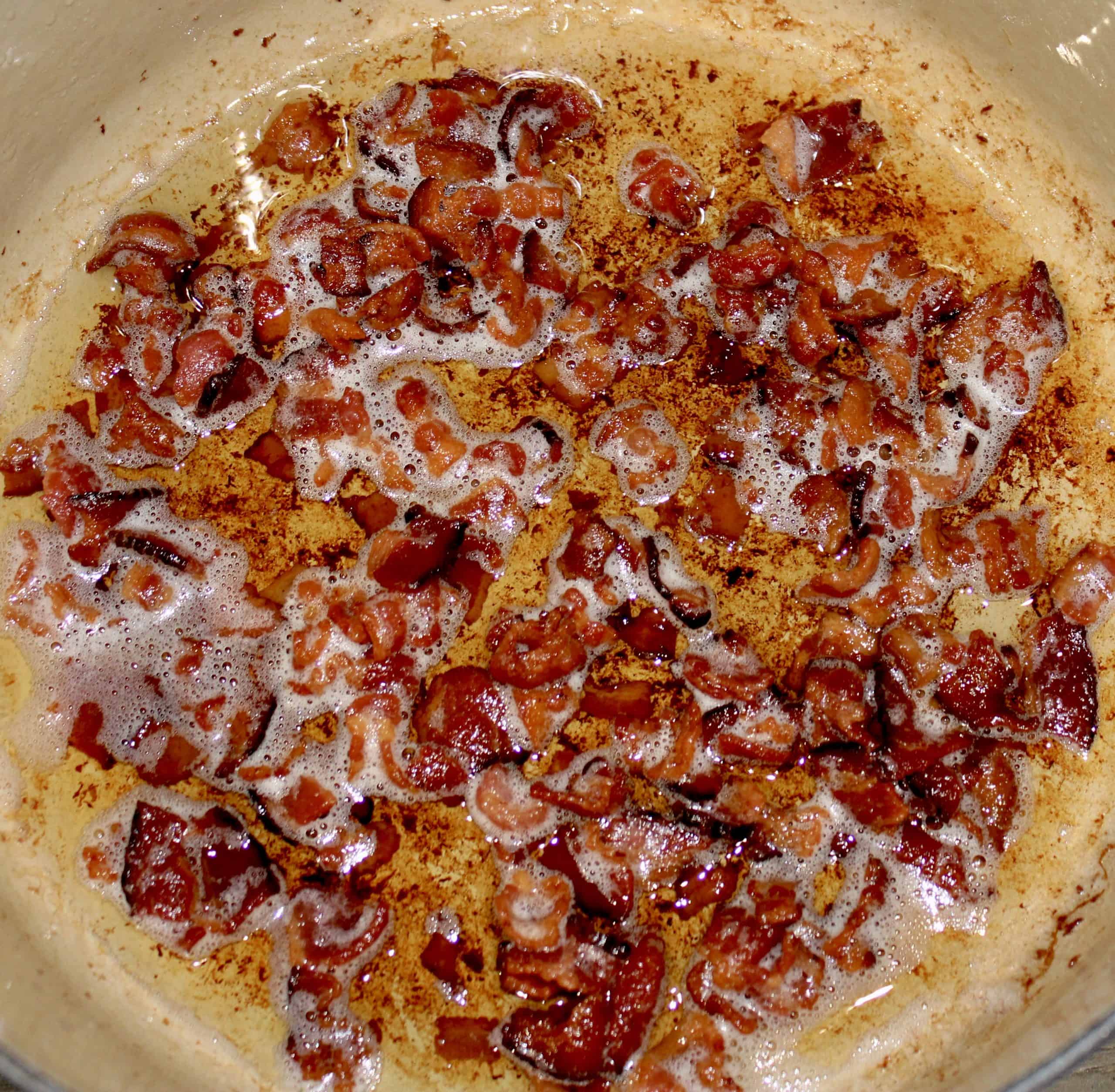 bacon chunks frying in pot
