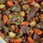 Beef Bourguignon in pot with parsley garnish