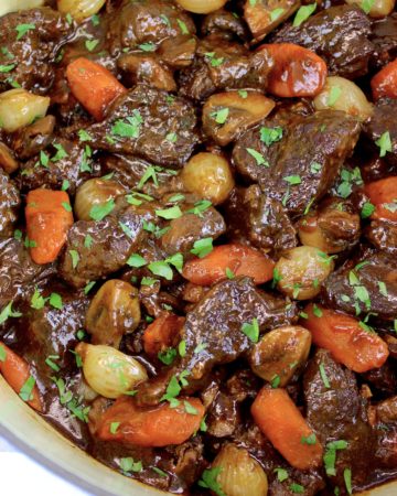 Beef Bourguignon in pot with parsley garnish