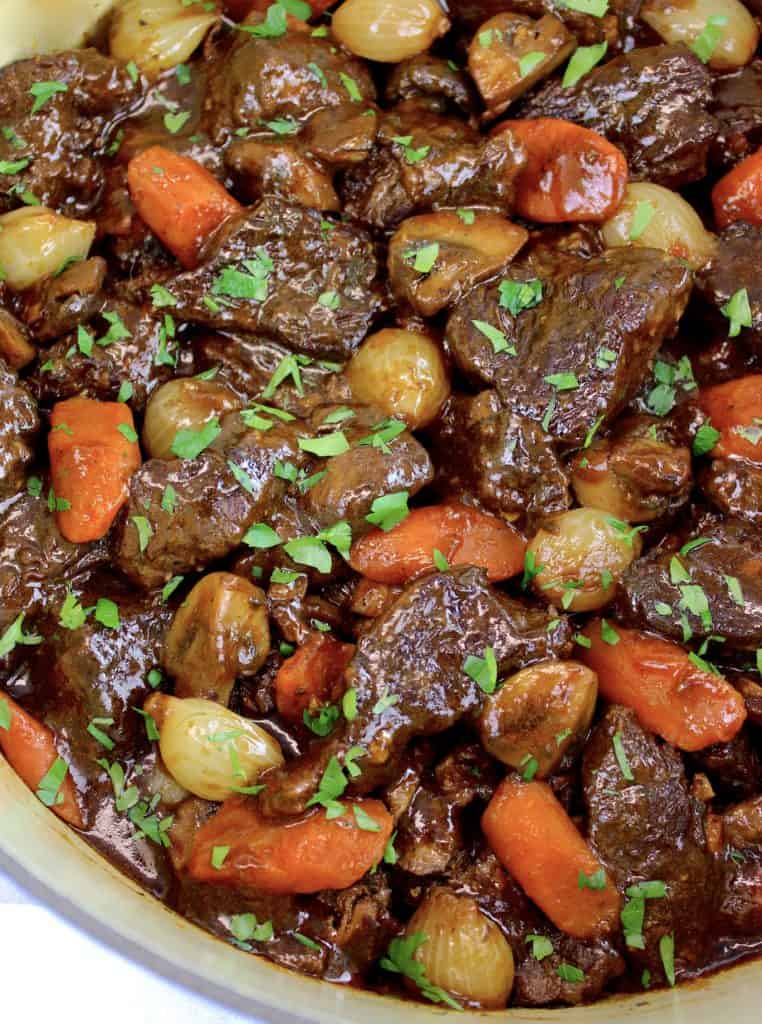 Beef Bourguignon in pot with parsley garnish