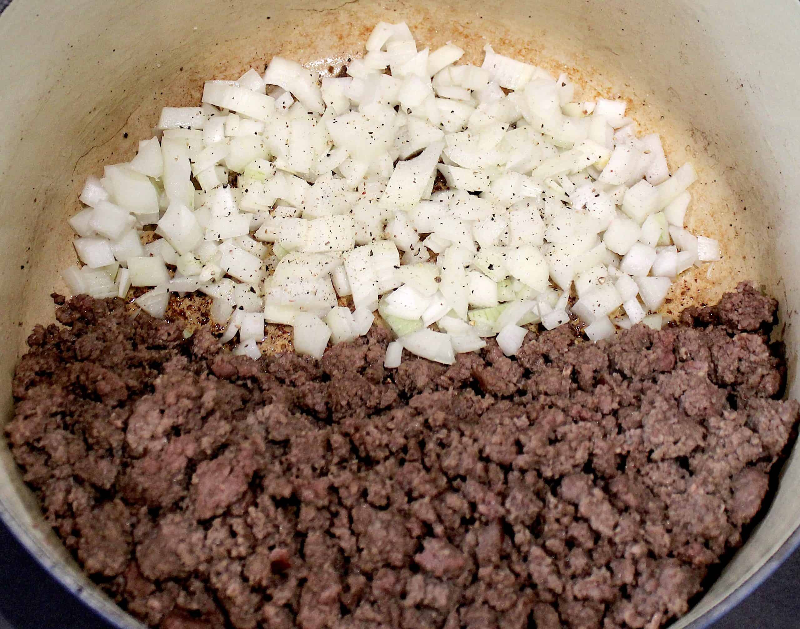 cooked ground beef and chopped onions in pot