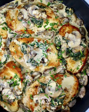 Chicken Florentine in skillet with mushrooms and spinach on top