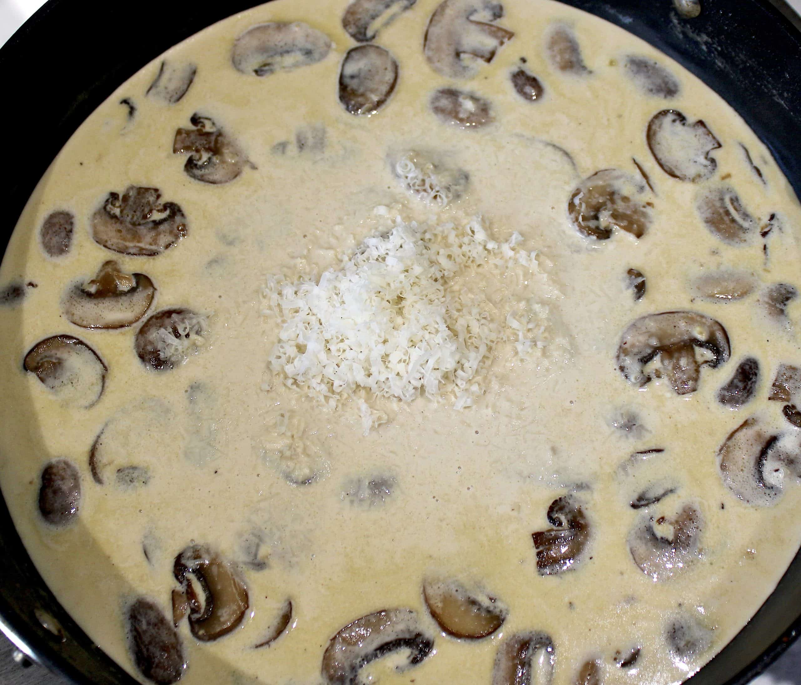 mushrooms in cream sauce with grated parmesan cheese in center