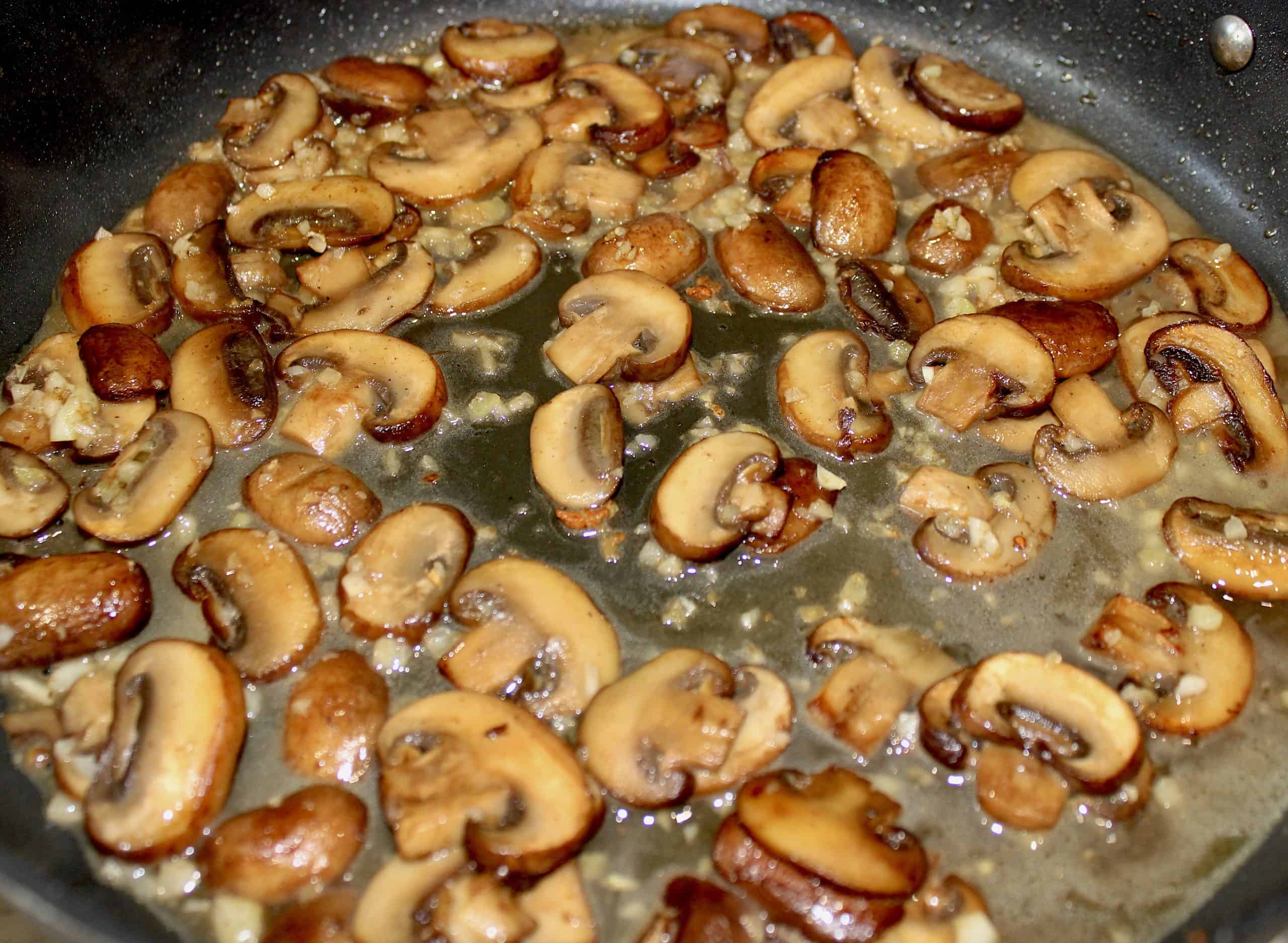 Sautéed mushrooms and garlic in skillet with white wine