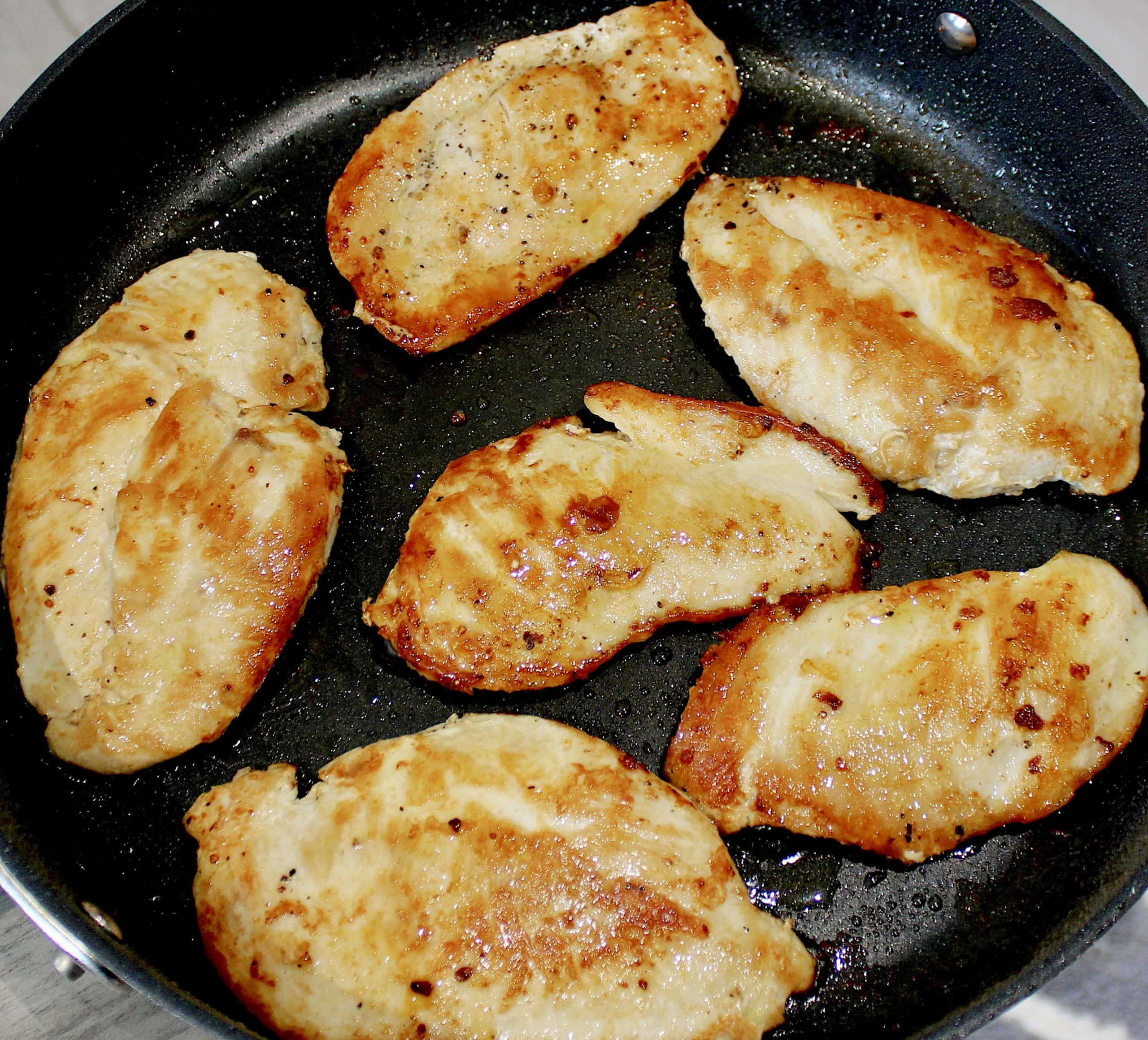 6 cooked chicken breasts in skillet