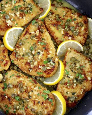 Chicken Piccata in skillet with lemon slices