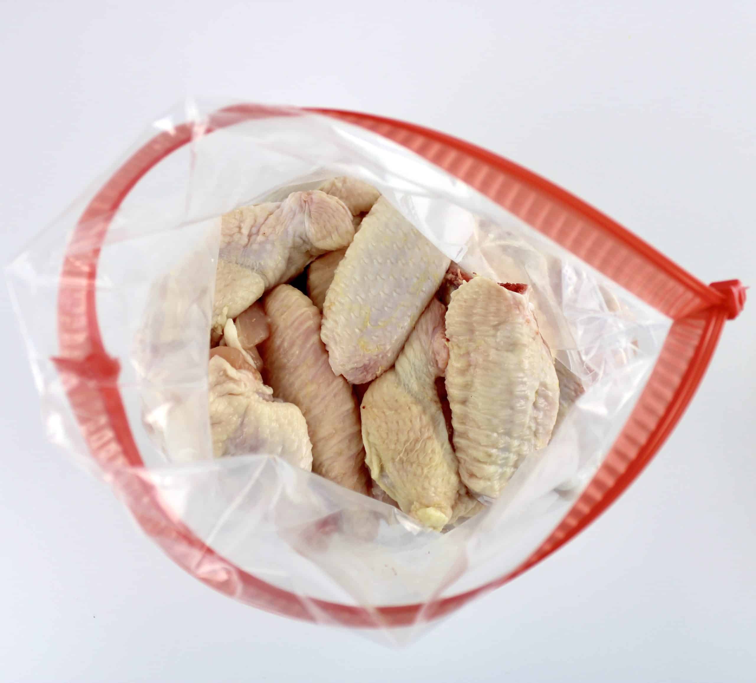 chicken wings in food storage bag with red zipper